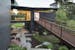 An innovative sculptural home featuring a front entry Corten steel walkway and enclosed glass bridge near Stillwater, designed by SALA Architects.