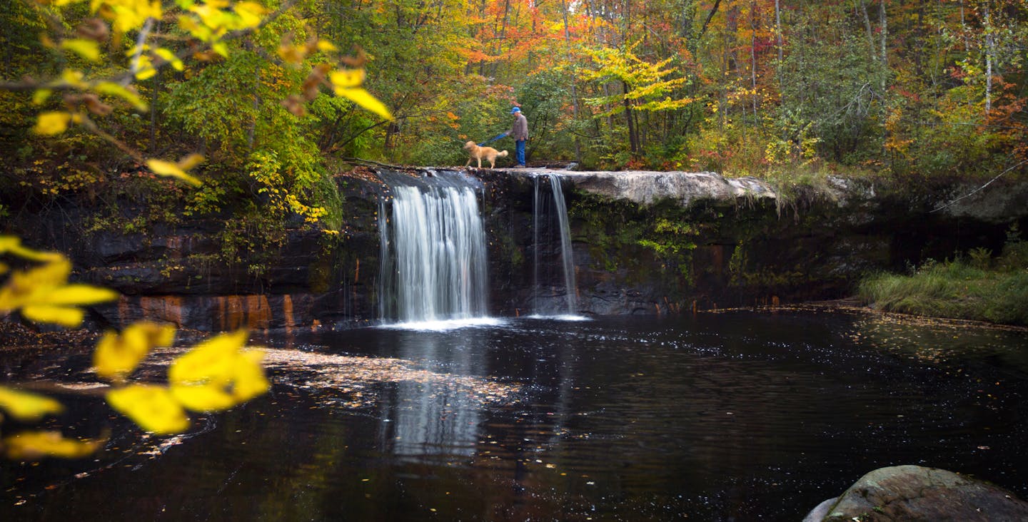 Larry Bostrom and his golden retriever Buddy, enjoy the fall color and Wolf Creek Falls at Banning State Park.] BRIAN PETERSON &#x201a;&#xc4;&#xa2; brianmpete@comcast.net Banning, MN 09/18/14