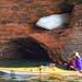 Ice formations at the Apostle Islands National Lakeshore? Julie Pelzl, from Lakeville, paddles by a chunk of ice that is still clinging on June 22. Cr