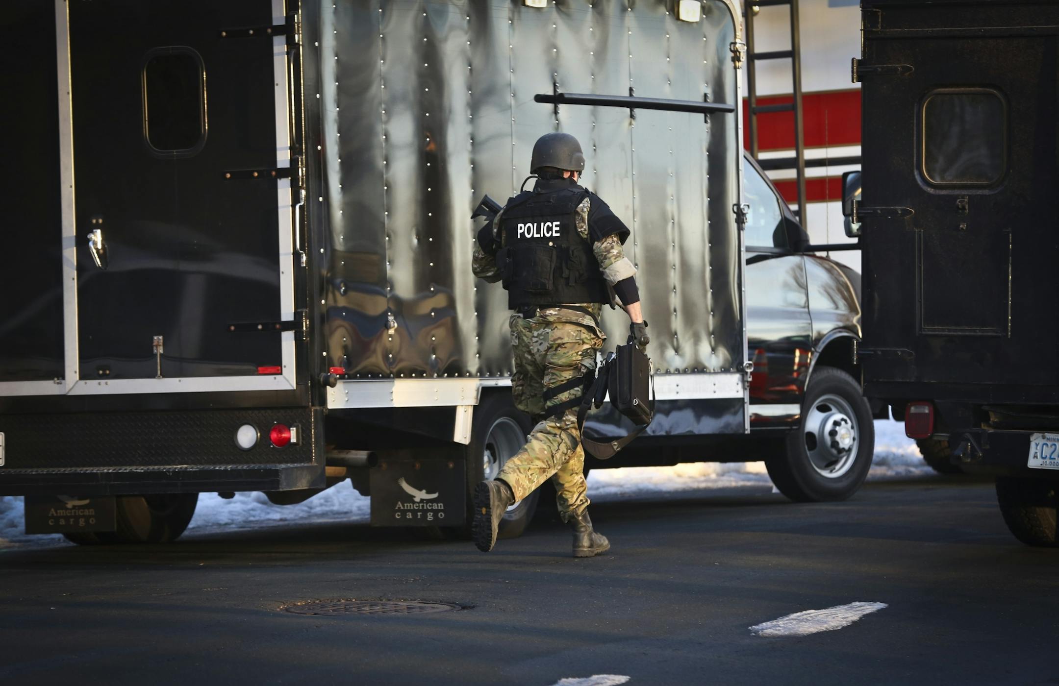 Swat team officers arrived to the scene of a man held up alone in a townhouse with a shotgun on Friday, January 18, 2013, in Maple Grove, Minn.