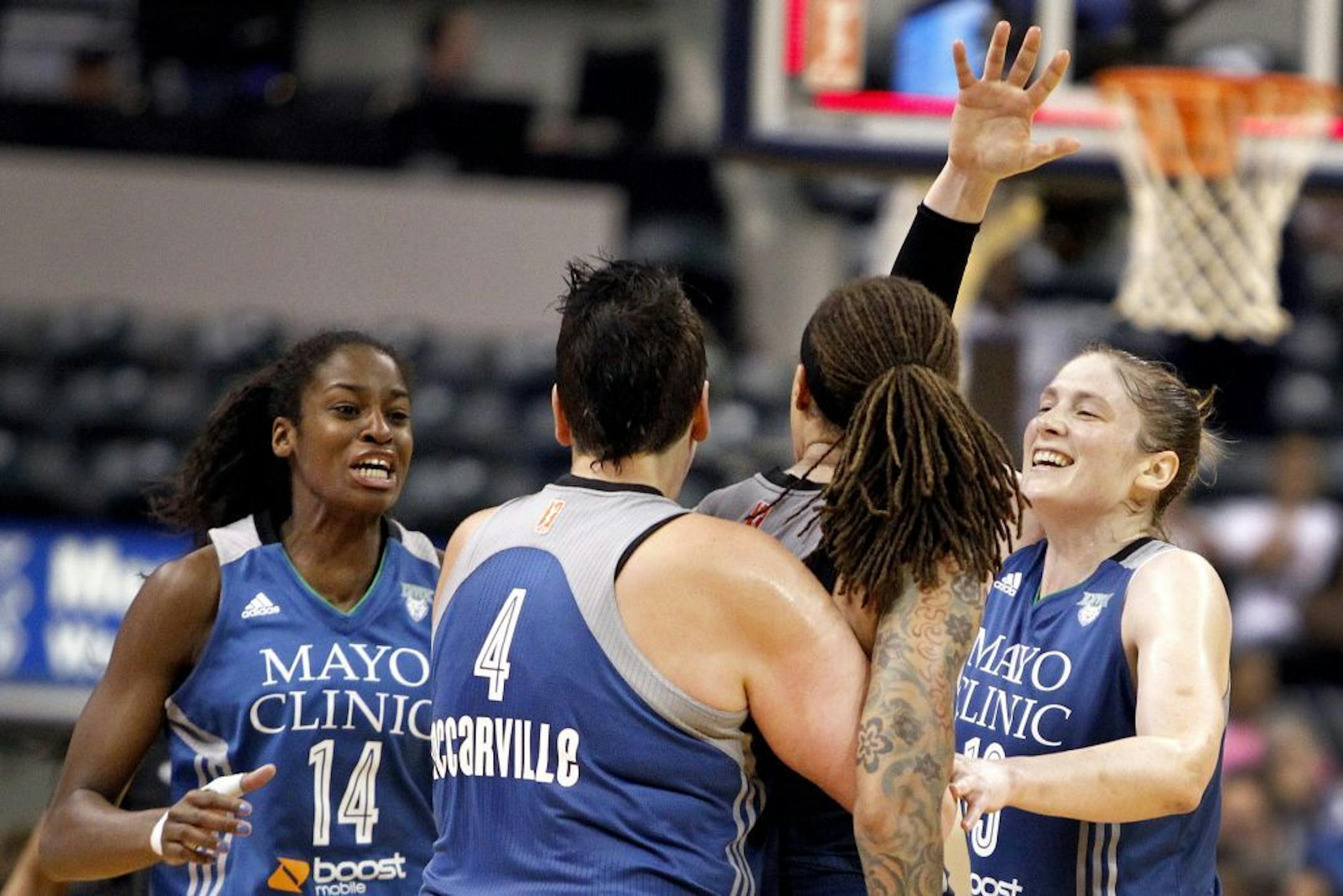 The Lynx's Devereaux Peters (14), Janel McCarville (4) and Lindsay Whalen congratulated teammate Seimone Augustus on her game-winning buzzer-beater against Indiana on Tuesday.