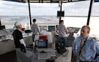 Air traffic controllers, including Justin Langerud, right, worked from the control tower at Minneapolis-St. Paul International Airport in April.