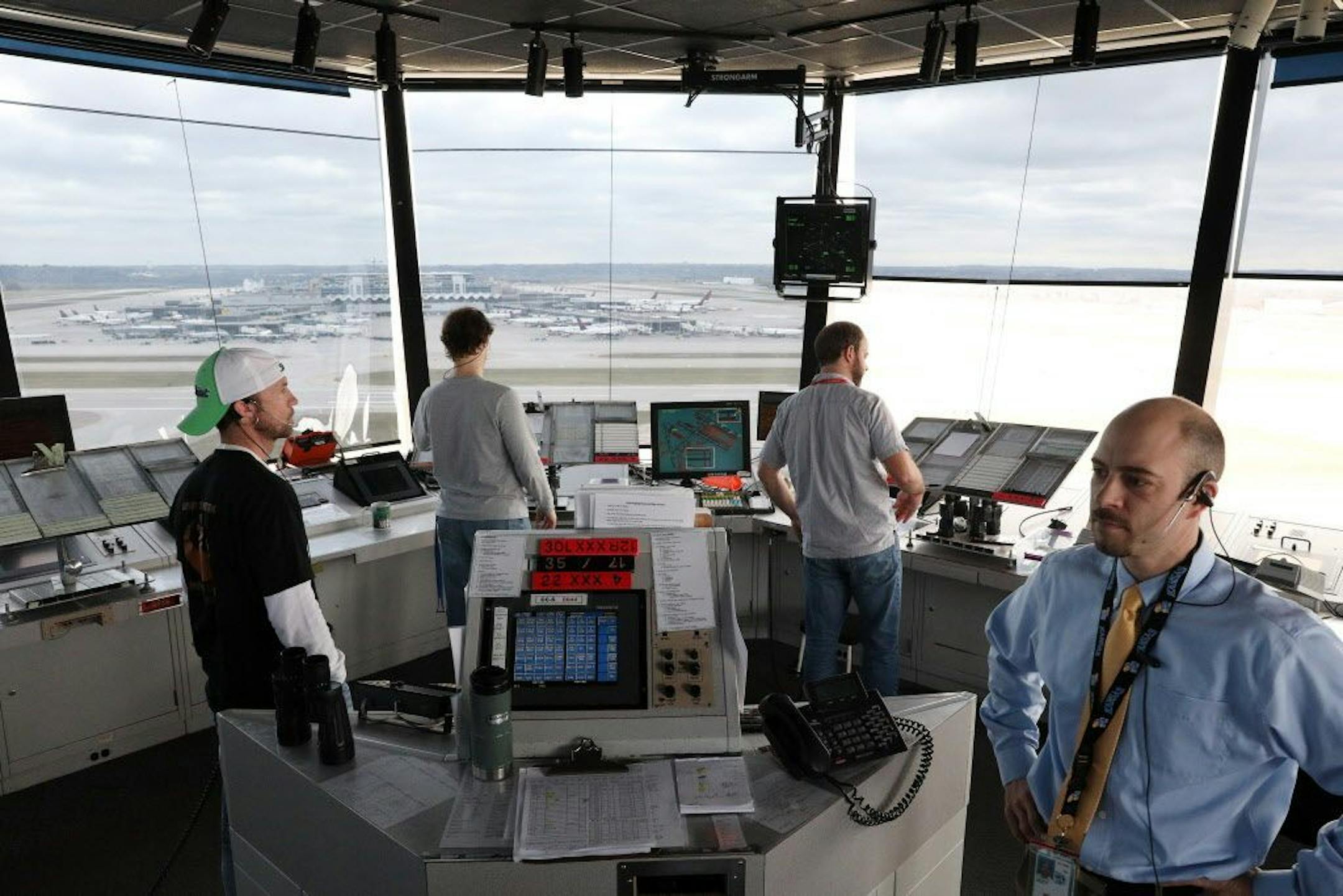 Air traffic controllers, including Justin Langerud, right, worked from the control tower at Minneapolis-St. Paul International Airport in April.