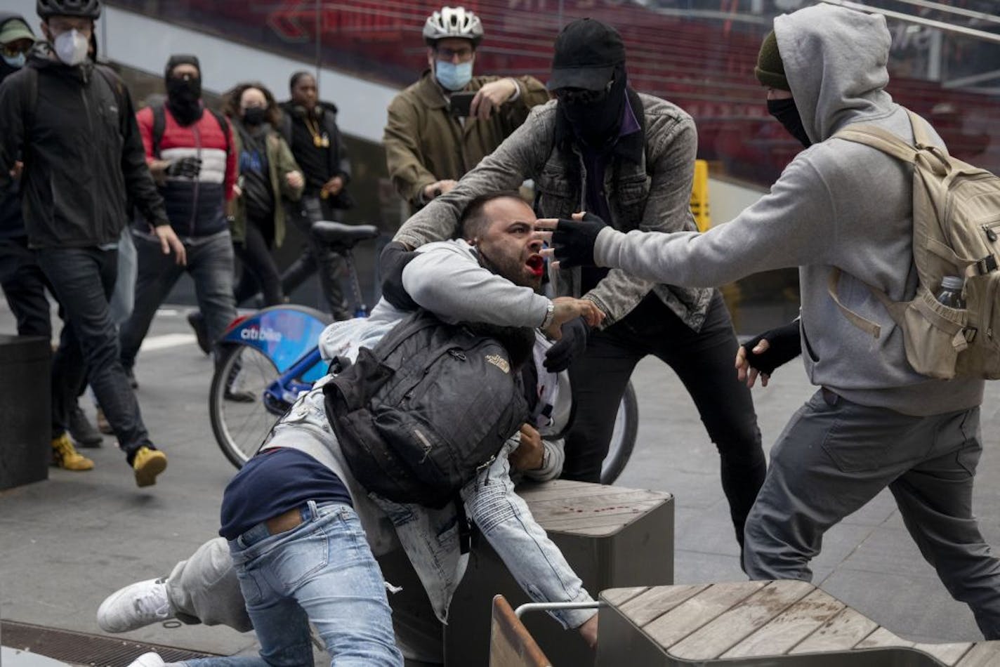 Supporters of President Donald Trump and counter-protestors clash in Manhattan's Times Square, Nov. 1, 2020. As the nation races toward Election Day, disruptions in New Jersey, Texas, Georgia, North Carolina and elsewhere reflect a bitter, uncertain election.