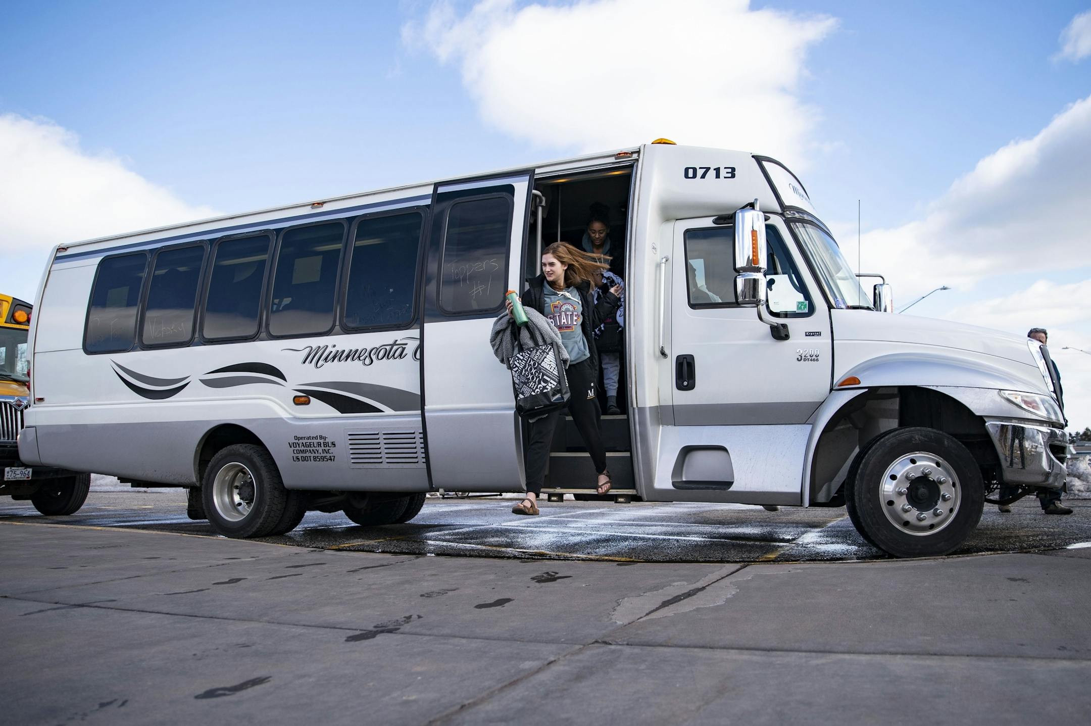 The Duluth Marshall girl's basketball team exited their bus in the parking lot of their school after driving back from Minneapolis on Friday.