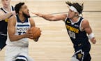 Wolves forward Karl-Anthony Towns worked on getting a shot against Nuggets forward Aaron Gordon during the first quarter of Sunday night's Game 4, whe