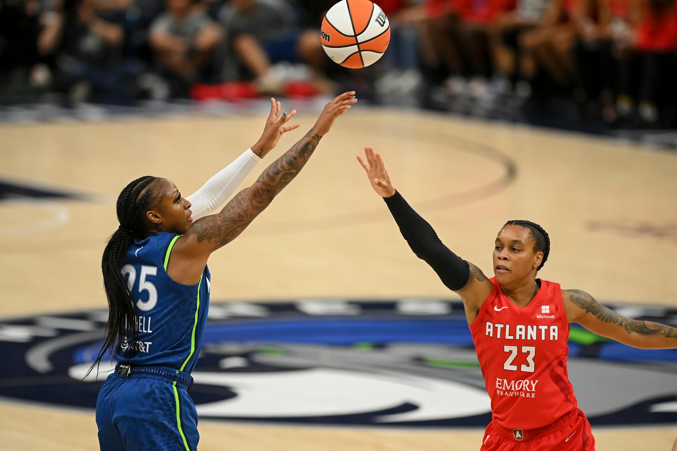 Minnesota Lynx guard Tiffany Mitchell attempts a 3-pointer as she's defended by Atlanta Dream guard AD Durr in the first quarter.