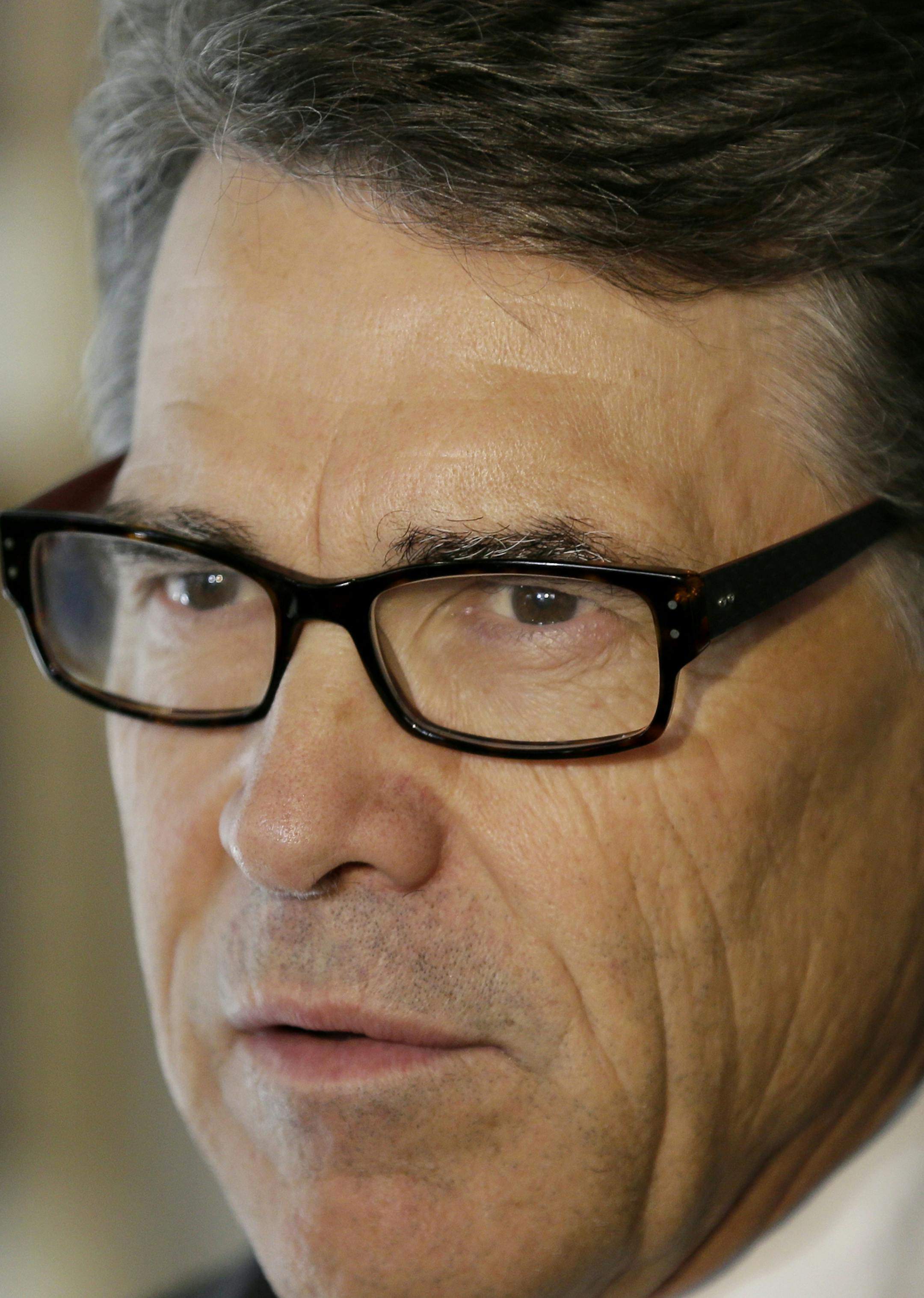 This photo taken May 29, 2014 shows Texas Gov. Rick Perry speaking in Ames, Iowa. Two leading Republicans have begun an unusually personal a war of words over foreign policy. The dispute between Kentucky Sen. Rand Paul and Texas Gov. Rick Perry highlights a broader divide within the GOP over international affairs in one of the first public clashes of the Republican Party’s looming presidential primary. (AP Photo/Charlie Neibergall)