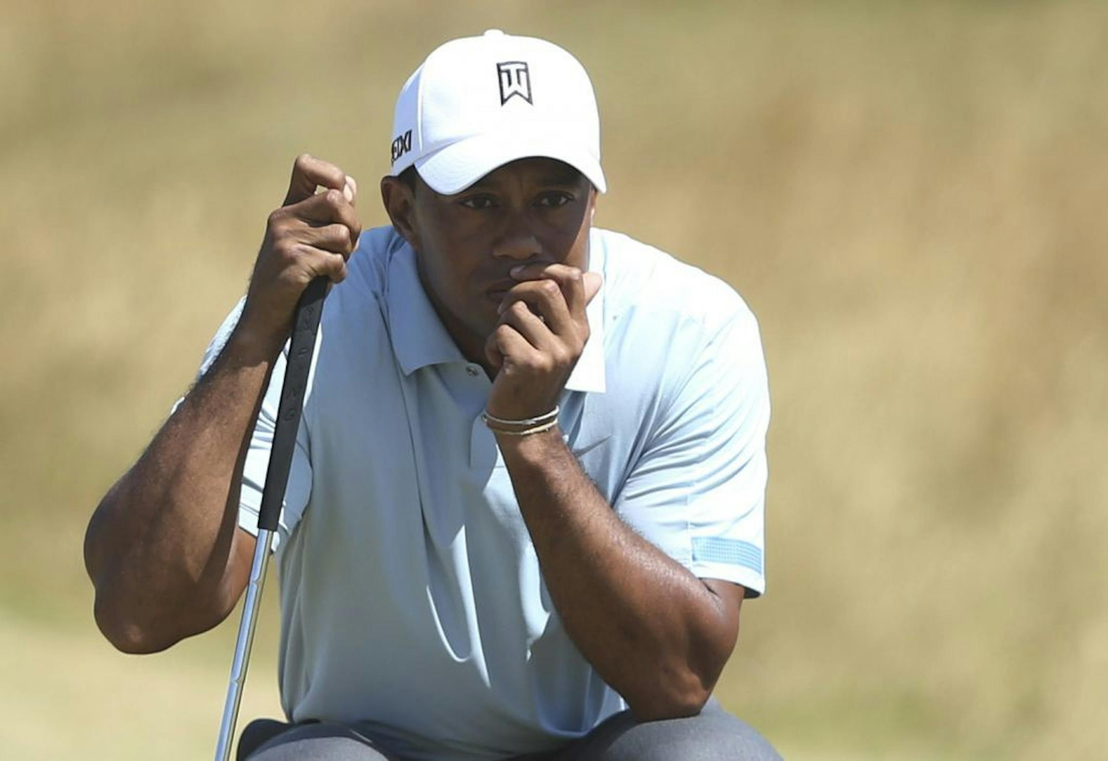 Tiger Woods of the United States lines up a putt on the 14th green during the second round of the British Open Golf Championship at Muirfield, Scotland, Friday July 19, 2013.