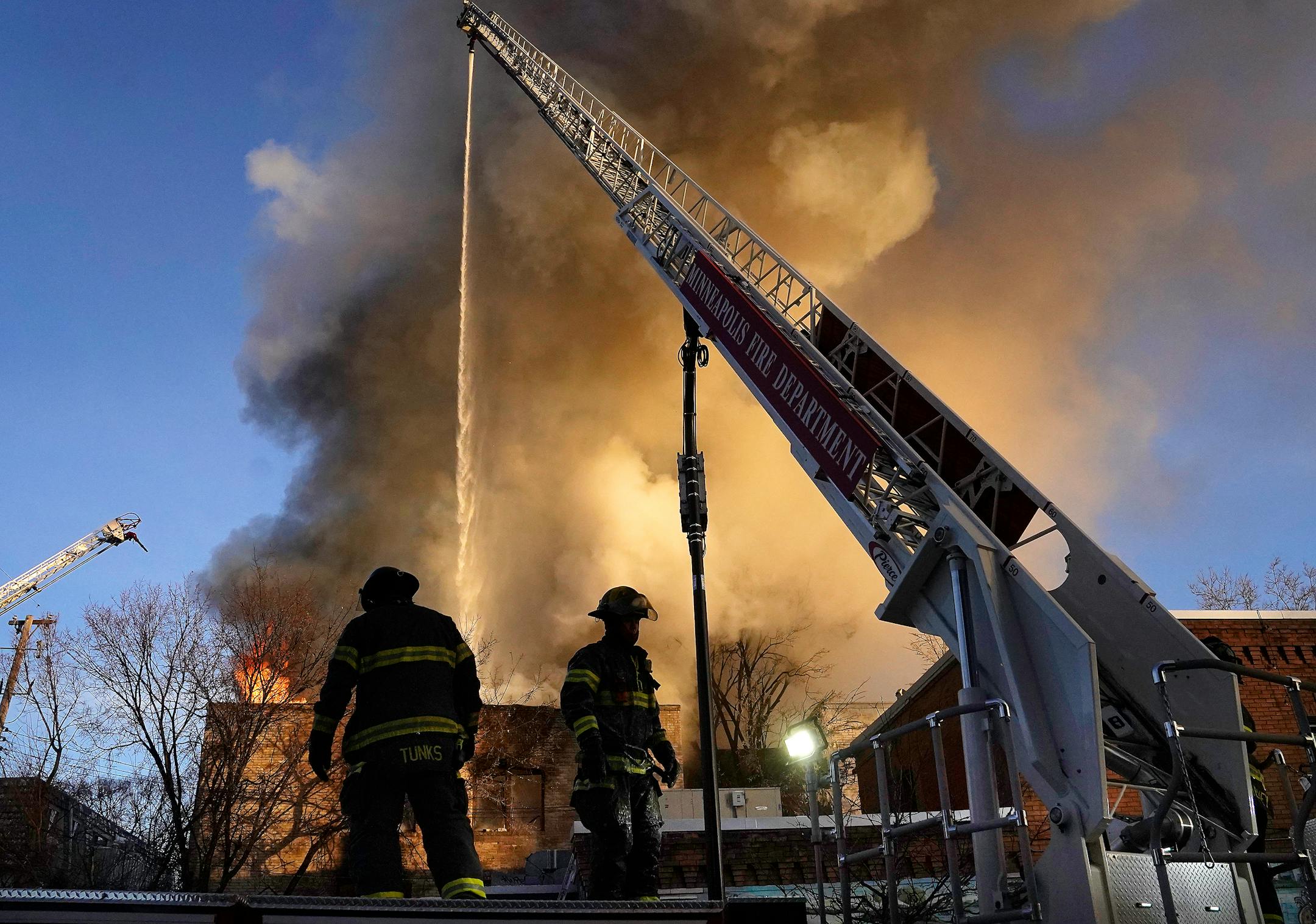 Minneapolis firefighters work a fire from an aerial ladder truck as a fire destroyed an empty apartment complex in the 2300 block of Lyndale Ave. S. In the early morning Saturday, Dec. 3, 2022 in Minneapois, Minn.