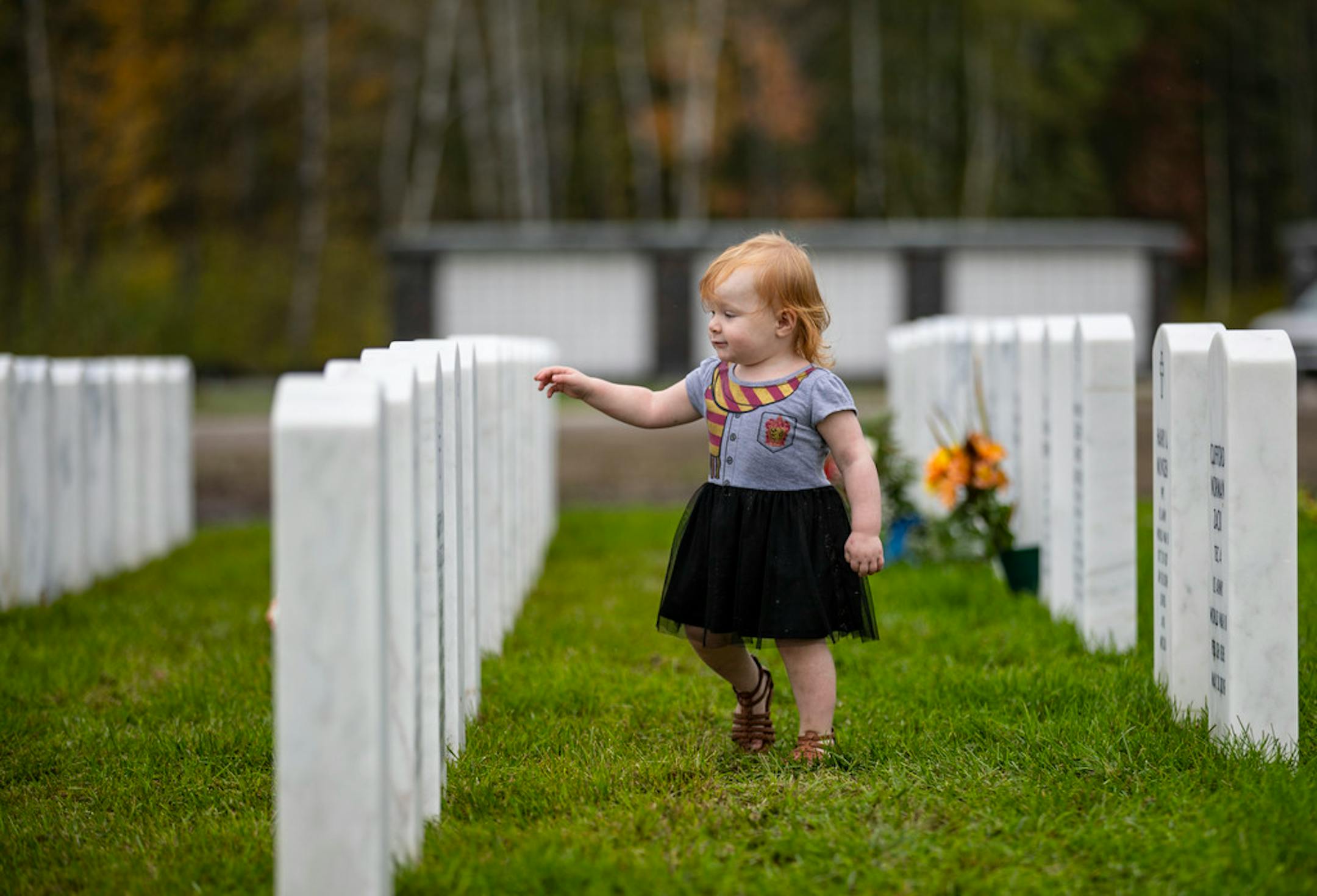 Melody Meierding ran through a row of gravestones recently added to the Minnesota State Veterans Cemetery in Duluth on Sept. 21, 2019.