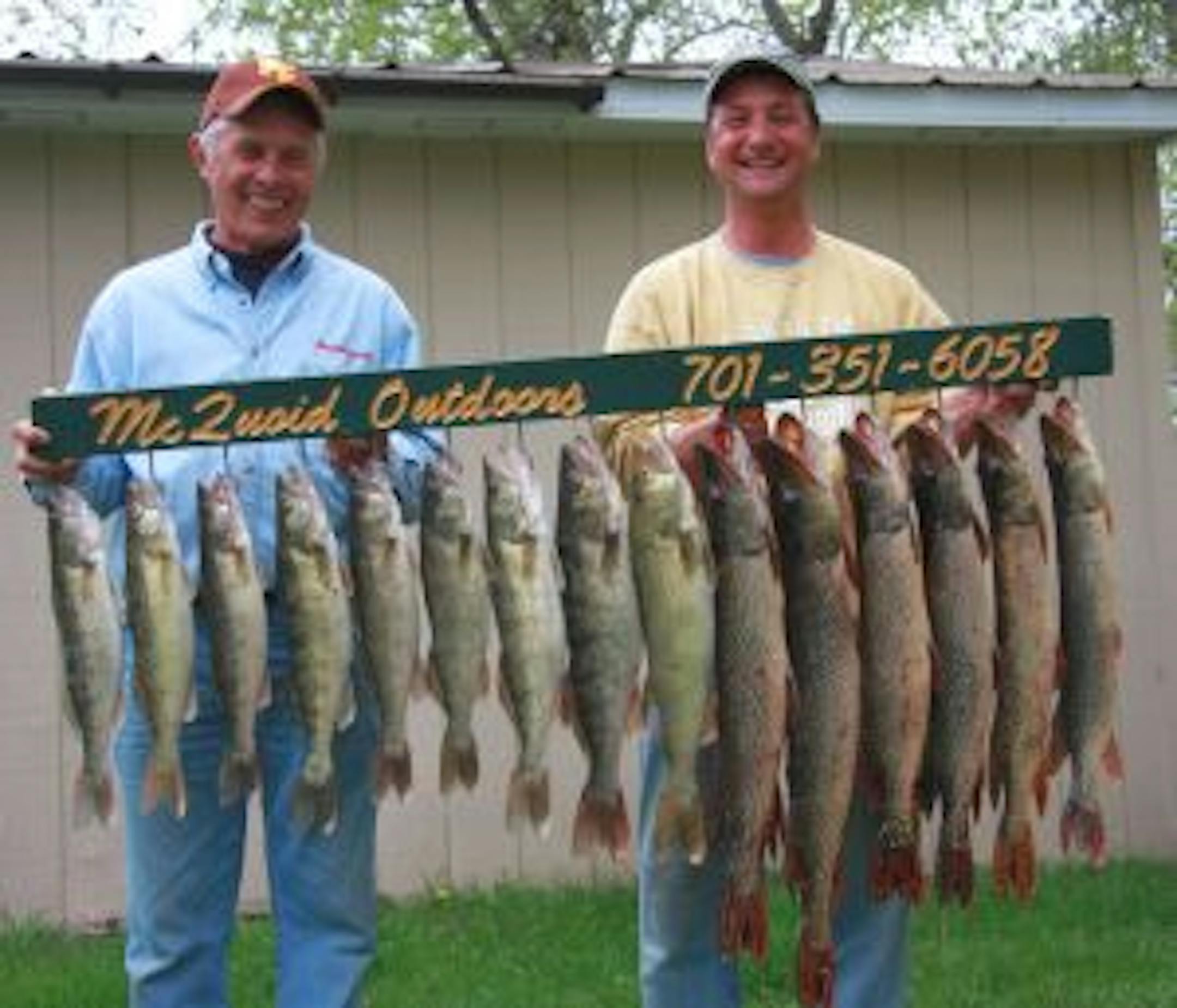 KFAN's "The Captain" Billy Hildebrand and Devils Lake guide Aaron McQuoid show off the day's catch