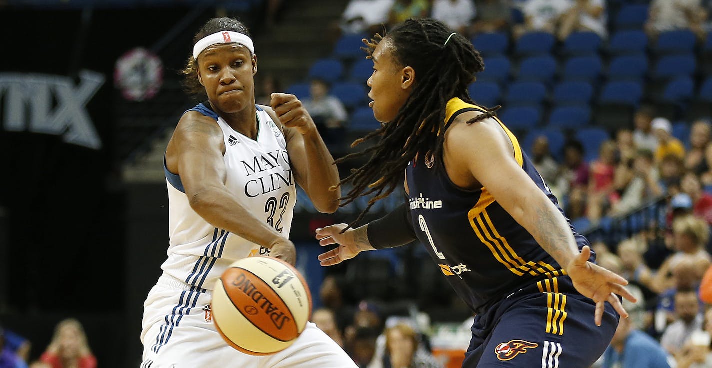 Minnesota Lynx forward Rebekkah Brunson (32) tries to pass the ball around Indiana Fever forward Erlanka Larkins during the first half of a WNBA basketball game, Friday, Sept. 4, 2015, in Minneapolis. (AP Photo/Stacy Bengs)