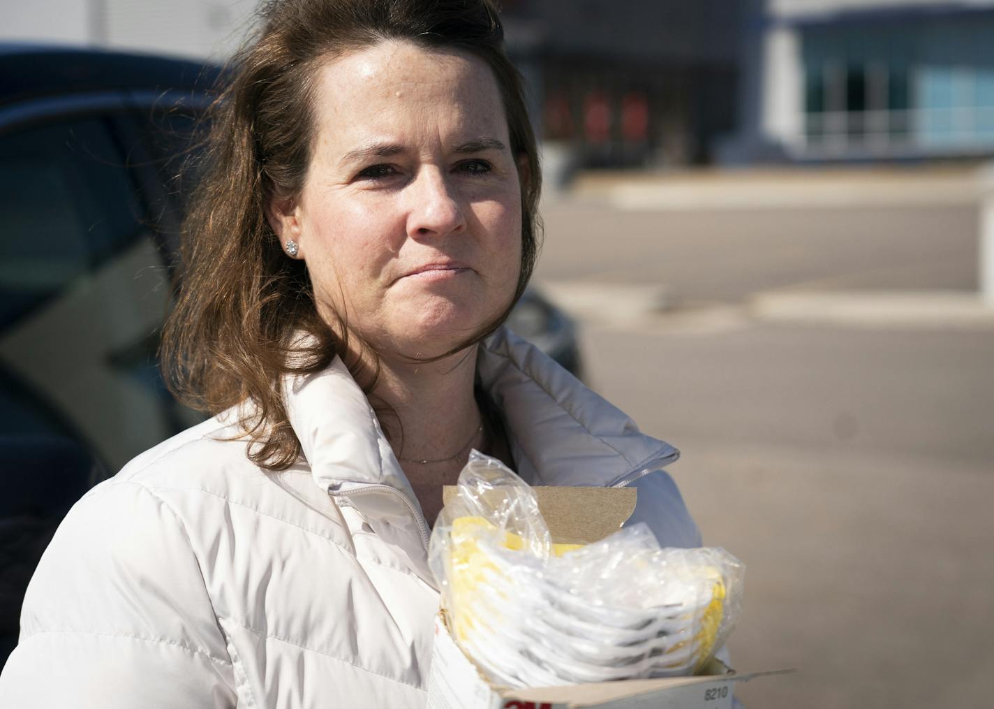 Kara Spike, a nurse at the COVID-19 unit at St. Joseph's Hospital in St. Paul, had a tear streaming down her face after she collected a box of respirator masks her brother had donated to her and her colleagues from his auto mechanic job in Minnetonka, Minn., on Friday, March 20, 2020. ] RENEE JONES SCHNEIDER &#xa5; renee.jones@startribune.com