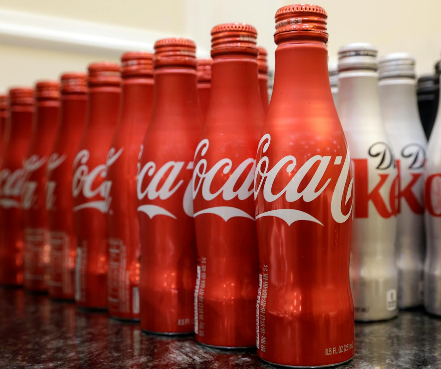 This March 7, 2015 photo shows 8.5 ounce bottles of Coca-Cola at the Cadillac Championship golf tournament in Doral, Fla. Coca-cola, which struggles with declining soda consumption in the U.S., is working with fitness and nutrition experts who suggest its cola as a healthy treat. (AP Photo/Wilfredo Lee)