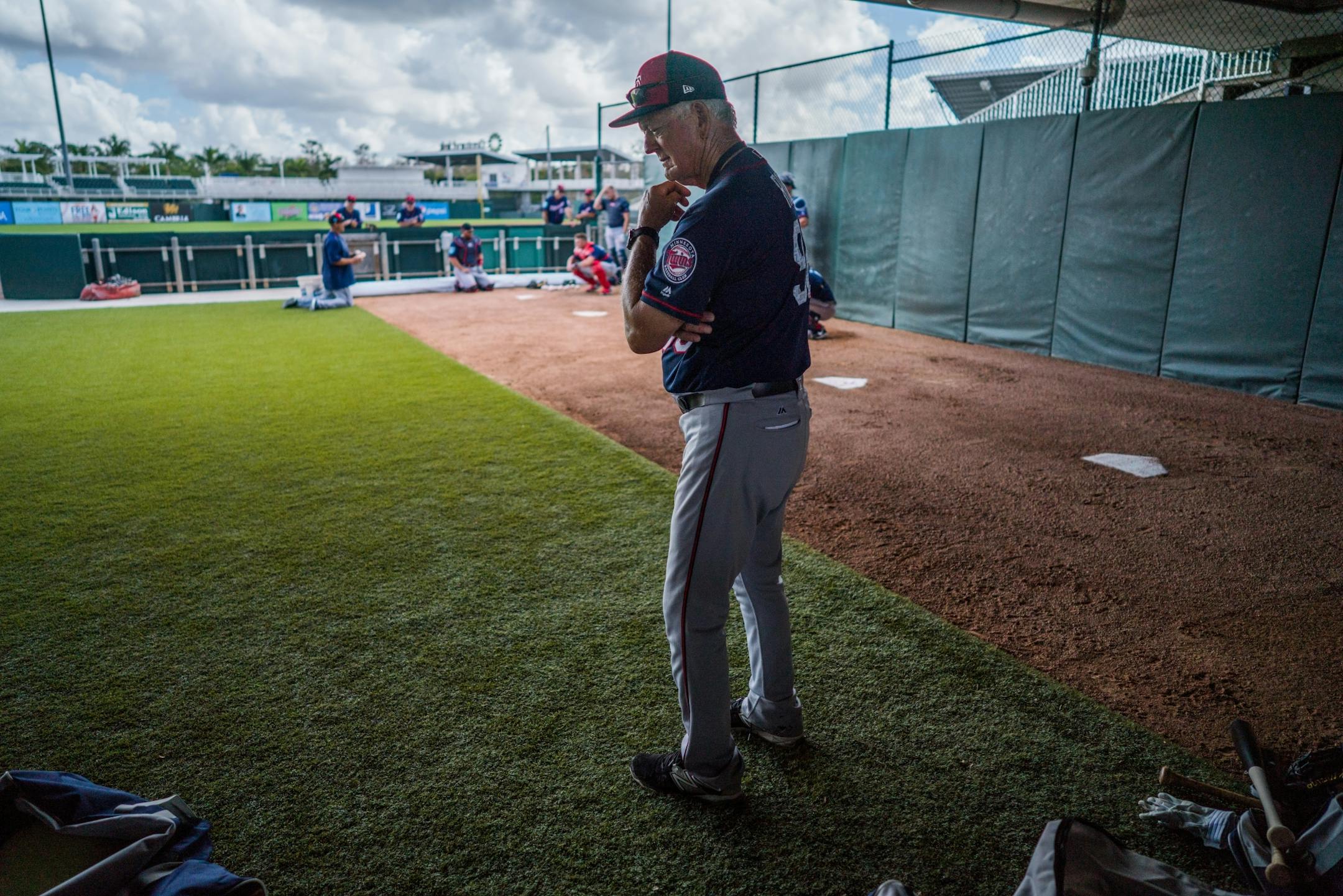 Twins minor league coach Phil Roof watches catchers' workouts.