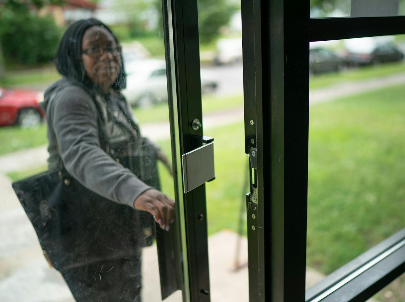 "The settlement would never have happened if it wasn't for the courage of the tenants speaking up," said Chloe Jackson, who also participated in the lawsuit. Above, she entered her apartment through a door with a broken lock.