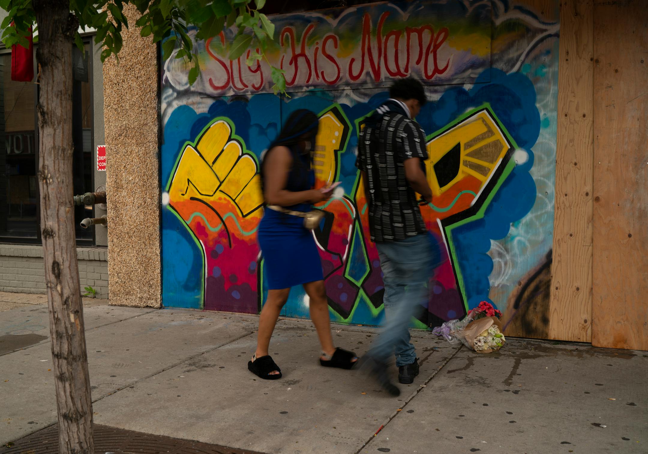 Flowers were left Sunday evening on a sidewalk in the Uptown area of Minneapolis, where the shootings took place earlier in the day.