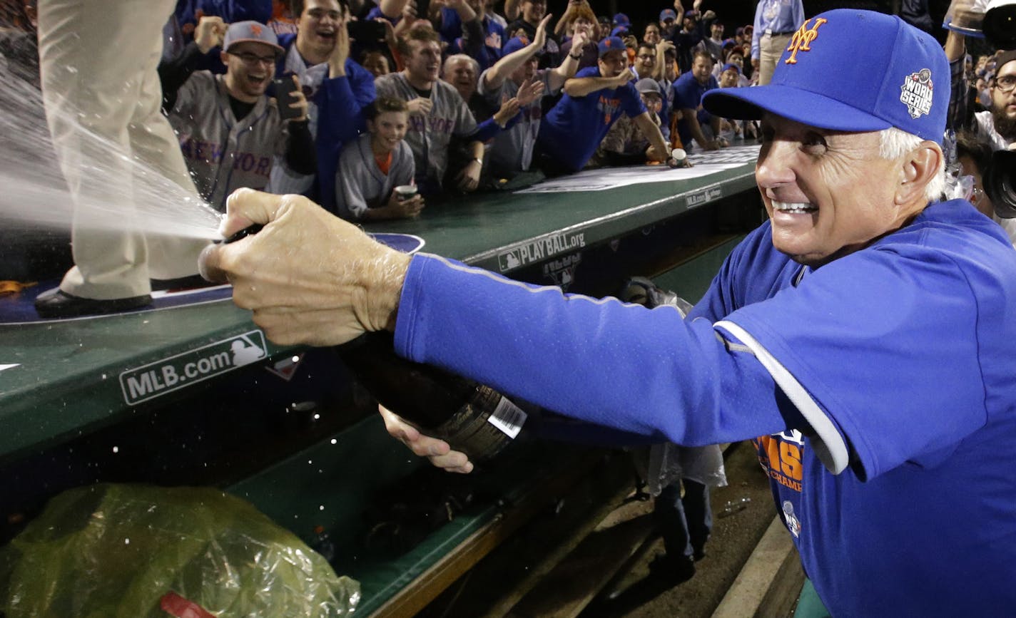 New York Mets manager Terry Collins sprays the crowd after Game 4 of the National League baseball championship series against the Chicago Cubs Wednesday, Oct. 21, 2015, in Chicago. The Mets won 8-3 to advance to the World Series. (AP Photo/Nam Y. Huh)