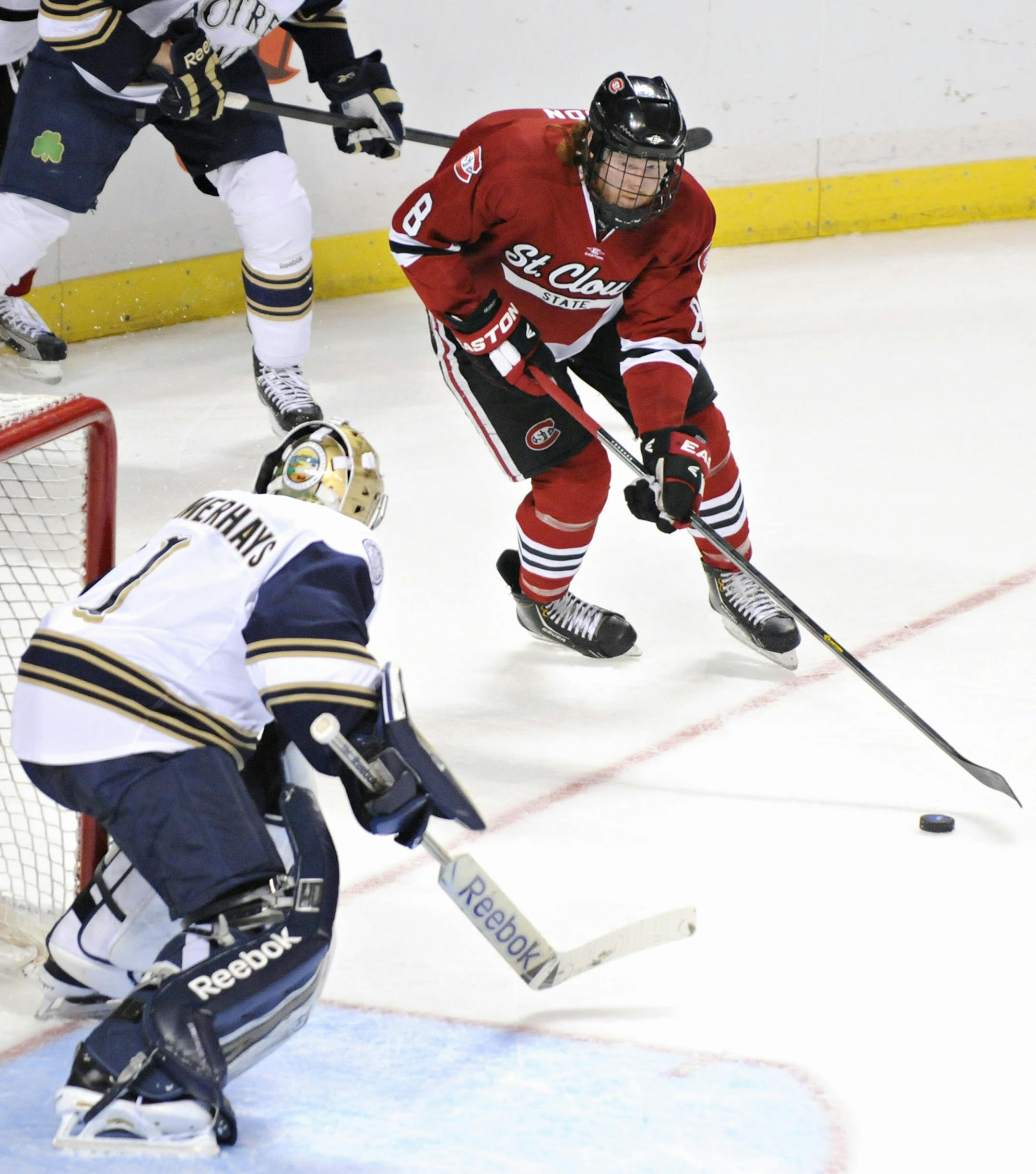 St. Cloud State's Cory Thorson (8) fires the puck past Notre Dame goalie Steven Summerhays to score during the second period of the NCAA college hockey Midwest regional semifinal tournament game, Saturday, March 30, 2013, in Toledo, Ohio, St. Cloud State defeated Notre Dame 5-1 and advances to the finals Sunday. (AP Photo/St. Cloud Times, Jason Wachter) NO SALES