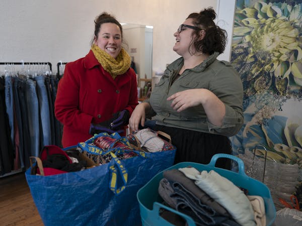 Kristen Jonet left, bought a bag clothing in to sell to Cat Polivoda owner at Cake Plus-Size Resale Sunday January 27, 2019 in Minneapolis, MN.] Jerry