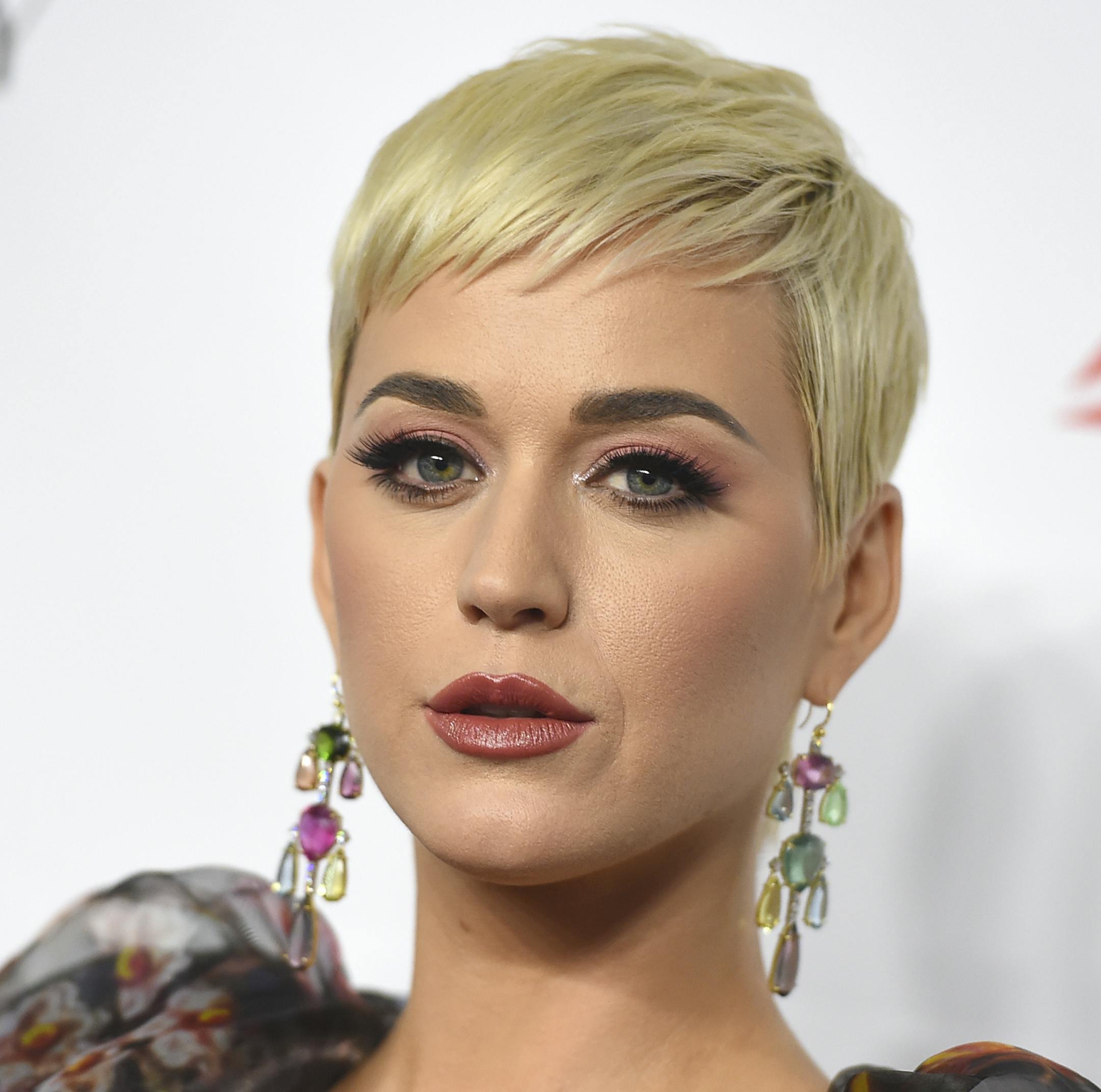 FILE - In this Feb. 8, 2019 file photo Katy Perry arrives at MusiCares Person of the Year honoring Dolly Parton in Los Angeles. Perry’s fashion line has pulled two types of shoes after some people compared them to blackface. The Ora Face Block Heel and Rue Face Slip-On Loafers were released last summer in nine different colors. They included protruding eyes, nose and red lips. (Photo by Jordan Strauss/Invision/AP, File)