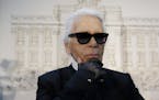 FILE - In this Monday, Jan. 28, 2013 file photo, Karl Lagerfeld poses for photographers prior to the start of a press conference, in Rome. Chanel's ic