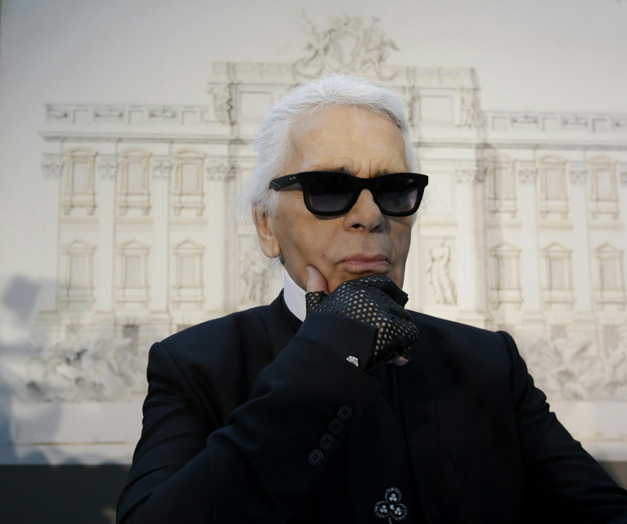 FILE - In this Monday, Jan. 28, 2013 file photo, Karl Lagerfeld poses for photographers prior to the start of a press conference, in Rome. Chanel's iconic couturier, Karl Lagerfeld, whose accomplished designs as well as trademark white ponytail, high starched collars and dark enigmatic glasses dominated high fashion for the last 50 years, has died. He was around 85 years old. (AP Photo/Gregorio Borgia, File)