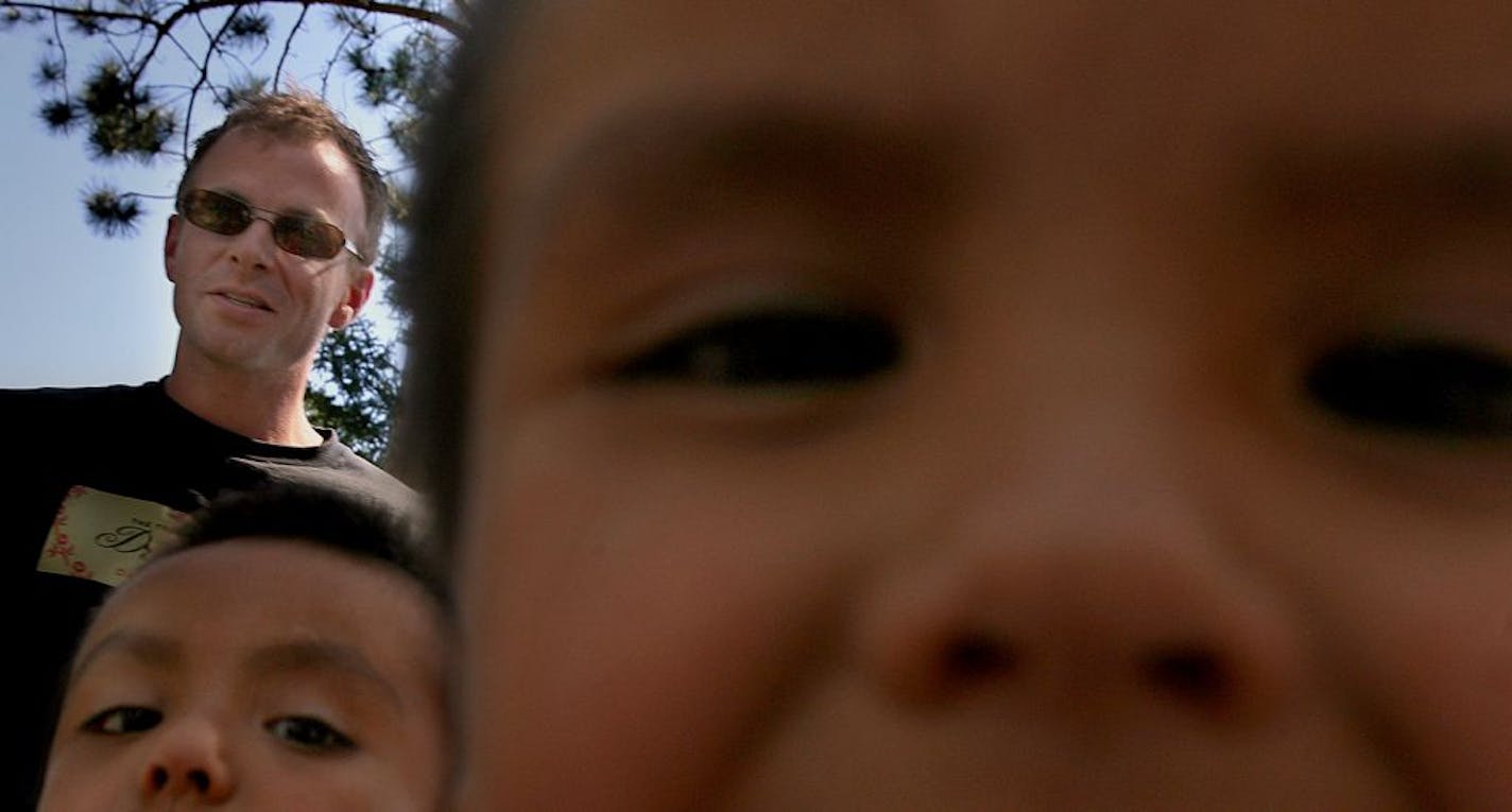 Author David Treuer visits the home of his brother, Anton (not pictured) on the Leech Lake Indian Reservation, where two of his nephews, Isaac and Elias, greet him.