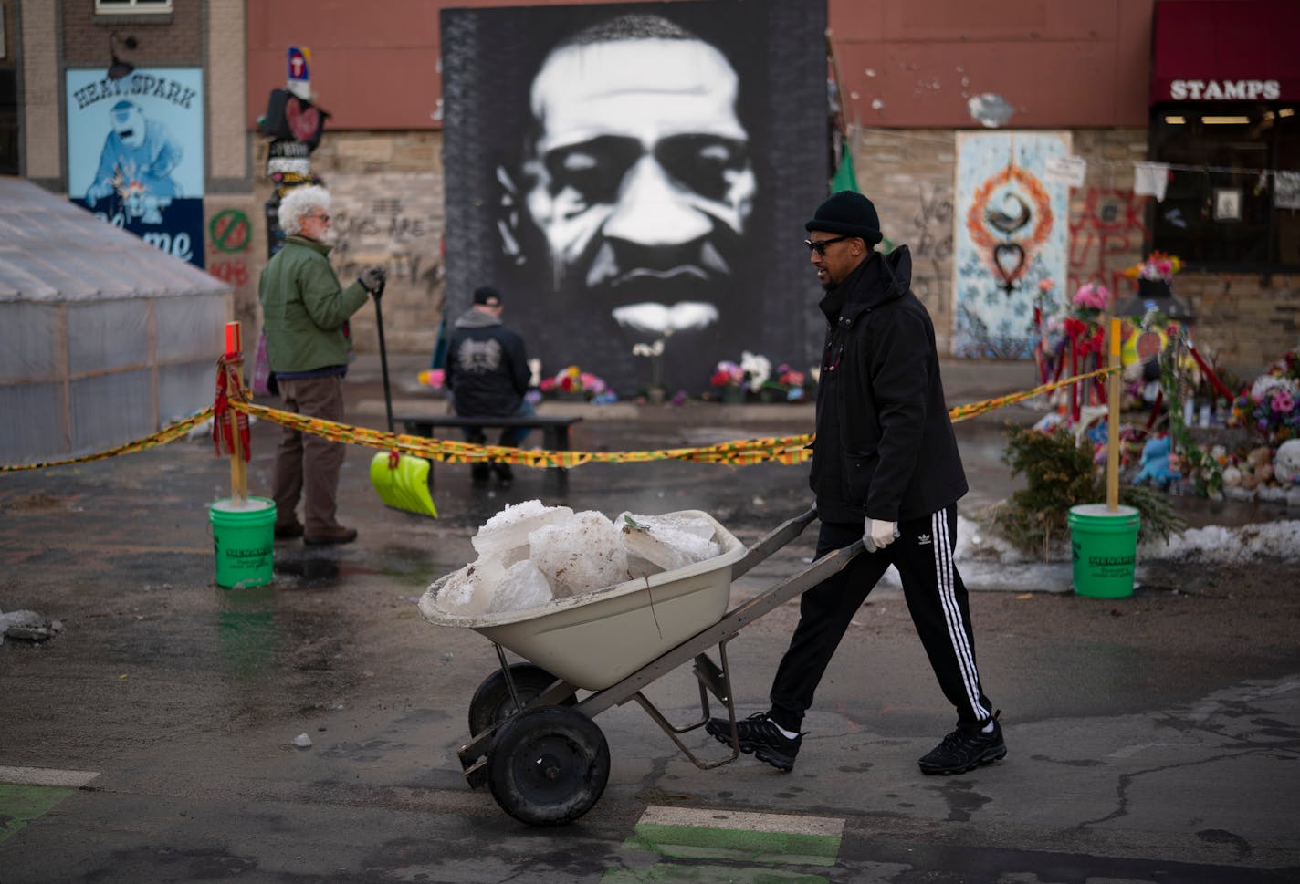 Tommy McBrayer was among the volunteers clearing ice from the street at George Floyd Square late Wednesday afternoon. He's also a community organizer in the Central neighborhood. ] JEFF WHEELER • jeff.wheeler@startribune.com