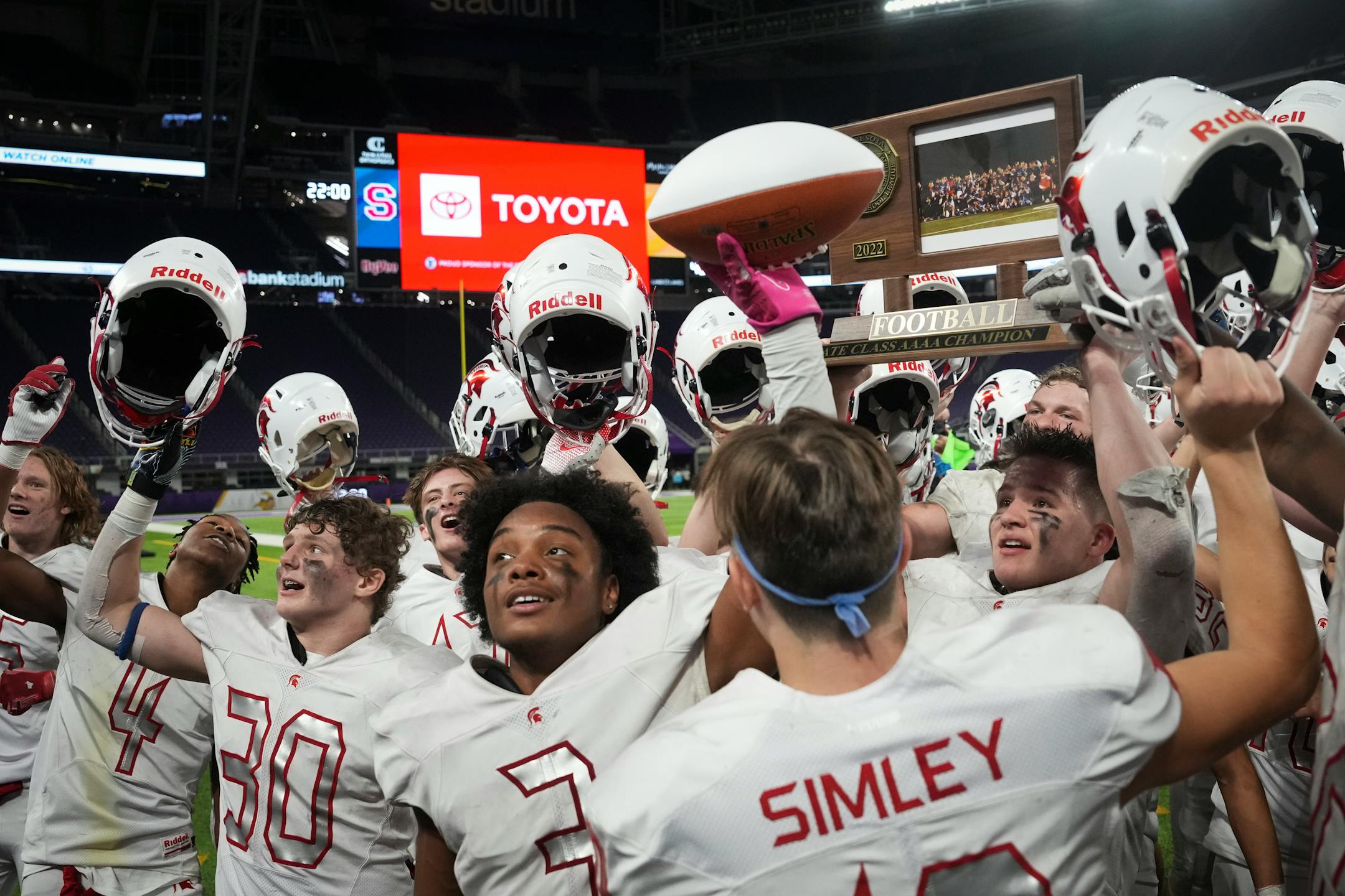 Simley Spartans teammates, including Simley Spartans running back David Gogins (3) and Simley Spartans quarterback Caden Renslow (10), ran to the fan section to celebrate after winning the game. Simley High School won 34-24 over defending champions Hutchinson.