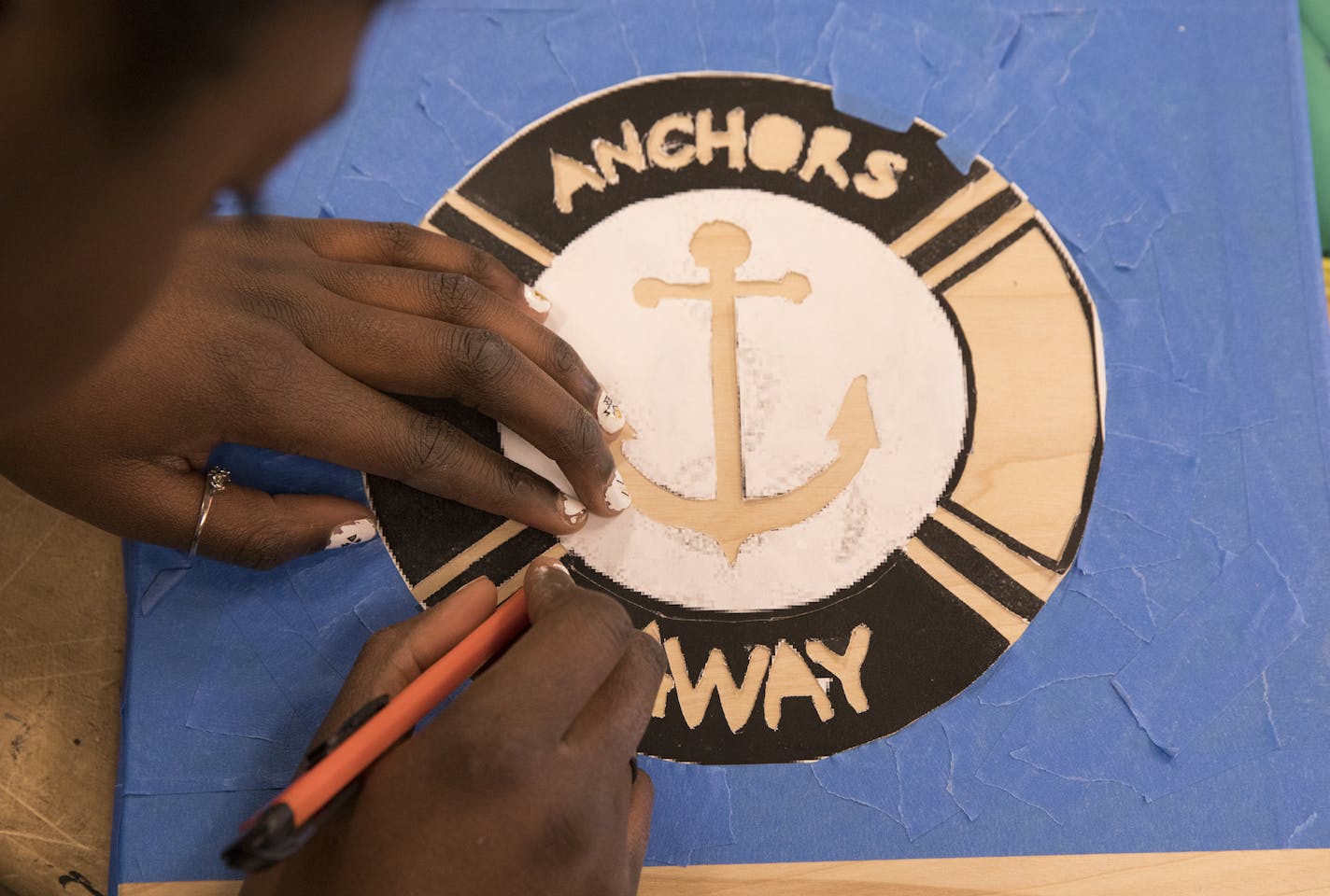 Adeline Billington, 16, works on the cut outs for painting a piece of wooden wall art she's making in engineering class. ] (Leila Navidi/Star Tribune) leila.navidi@startribune.com BACKGROUND INFORMATION: Girls work on their projects building furniture during Women in Engineering class at St. Anthony Village High School on Thursday, December 15, 2016. More than 25 girls participate in St. Anthony Village High School's all-girls engineering class. The girls are building furniture to give to charit