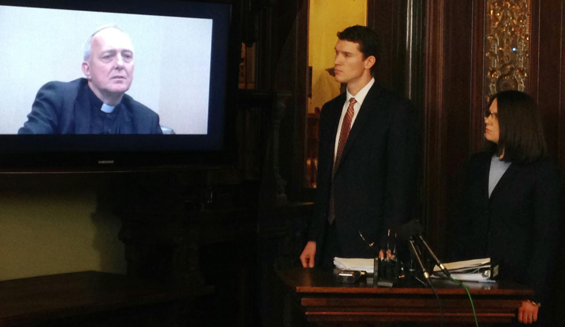 Attorneys watched video of the deposition of the Rev. Kevin McDonough during a news conference on Thursday.
