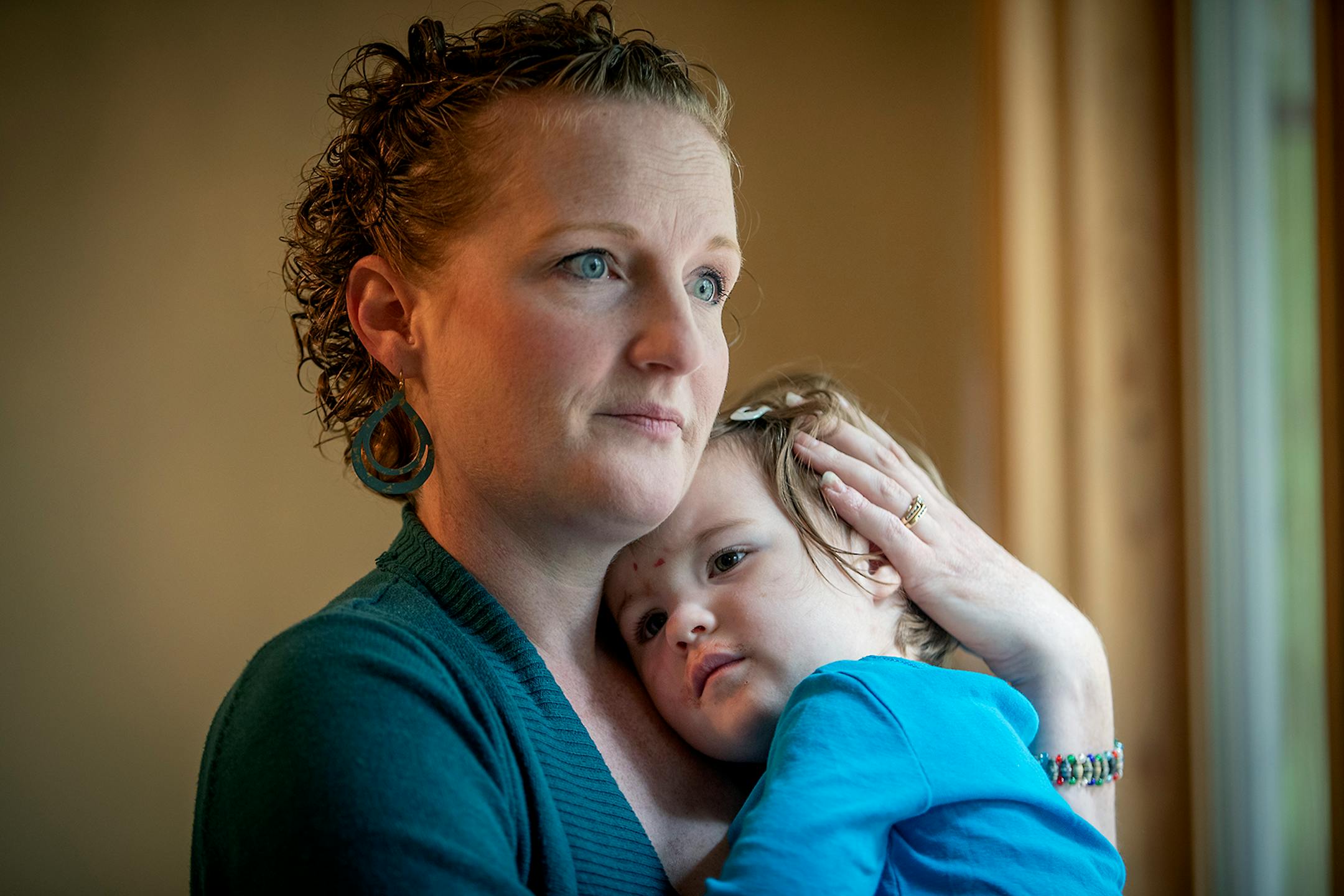 Kate Lundquist rocked her daughter Verabeth, 2, to sleep as she balanced parenting and school work from home, Tuesday, September 29, 2020 in Brooklyn Park, MN.