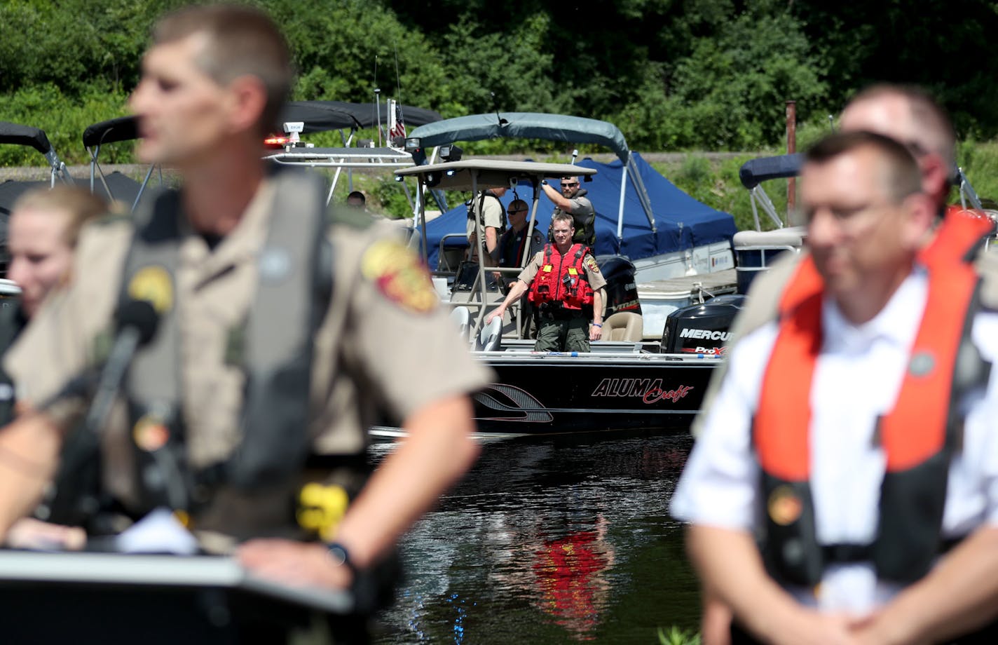 The DNR and other law enforcement agencies are kicking off Operation Dry Water, a concerted effort to crack down on drunken boaters this weekend. The goal: reducing the number of BWI accidents and fatalities. Here, law enforcement officers in boats watch as Lt. Adam Block, Minnesota DNR Enforcement boating law administrator, left, addressed media members at the press conference encouraging the word to get out that boating safety is a priority and that drinking and driving a boat will be highly m