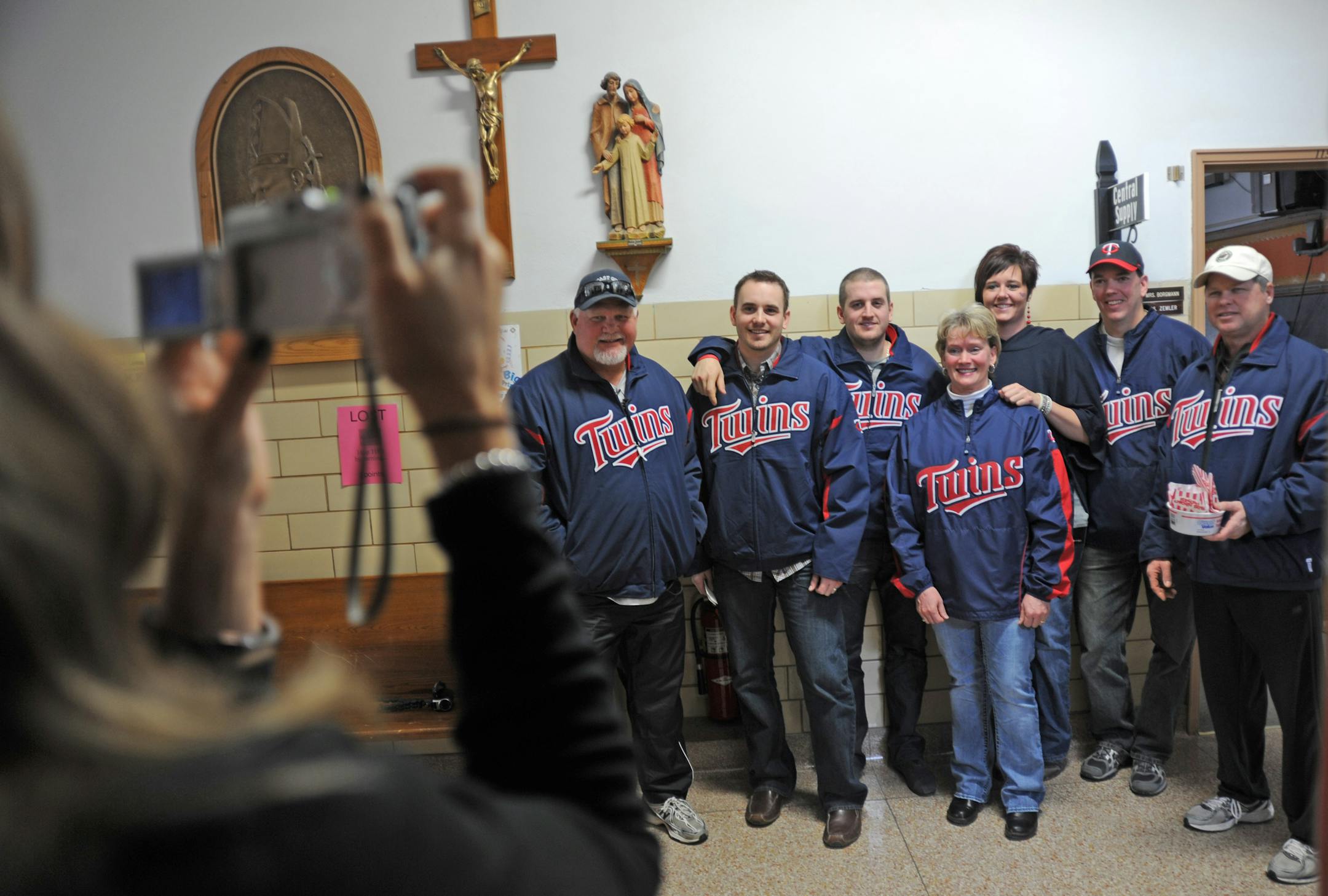 Twins manager Ron Gardenhire, left, and pitchers Brian Duensing and Glen Perkins posed for pictures with fans Monday at Holy Family School in Sauk Centre, Minn. It was the first stop on the annual Winter Caravan tour of the state.