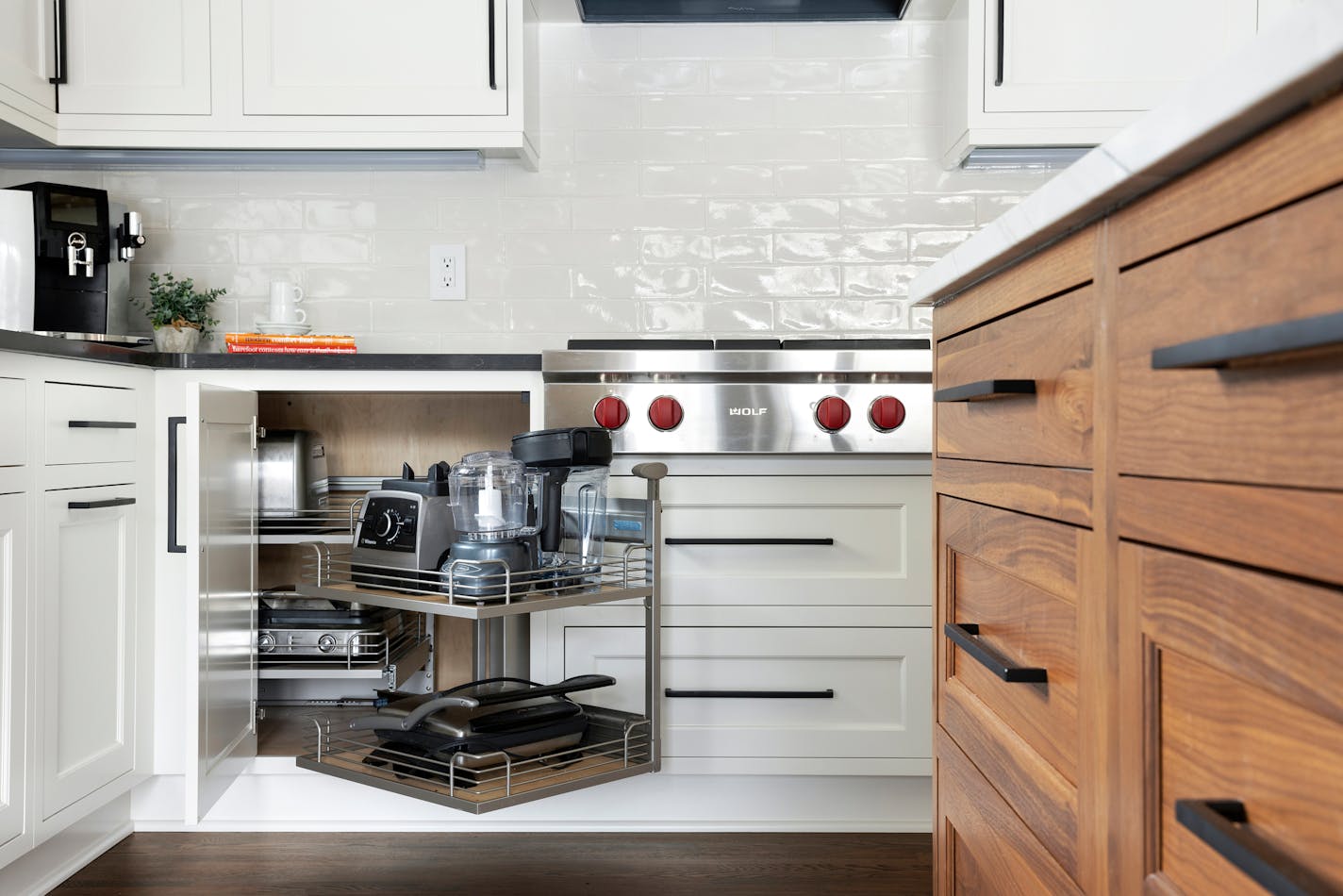 Double pullout shelves in a corner cabinet for accessing bulky appliances.