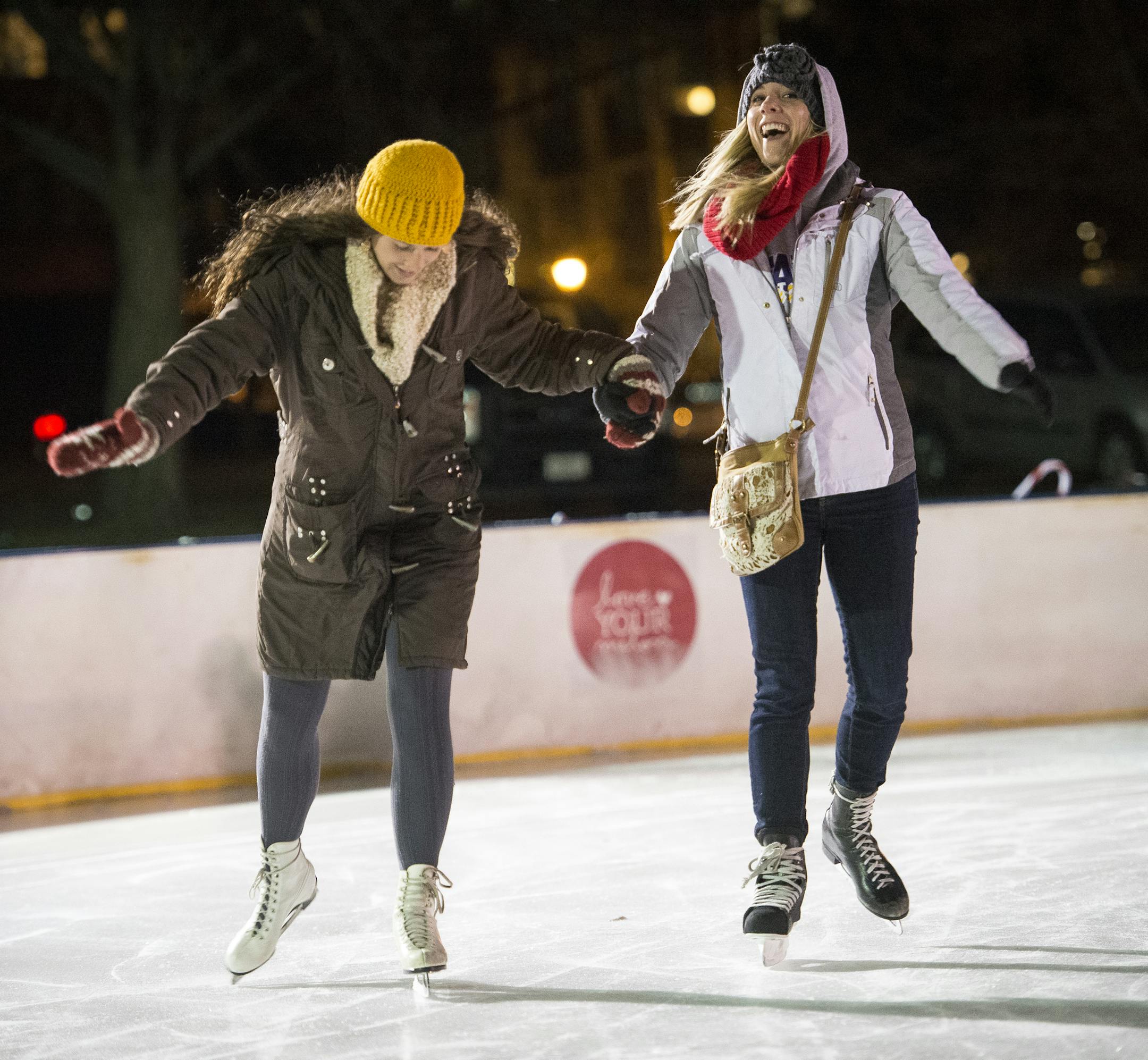 Kelsey Przymus, left, and Katie Weidner, both from Mankato, tested their ice skating skills Friday night at Holidazzle. The original Holidazzle started out as a downtown parade in 1992.