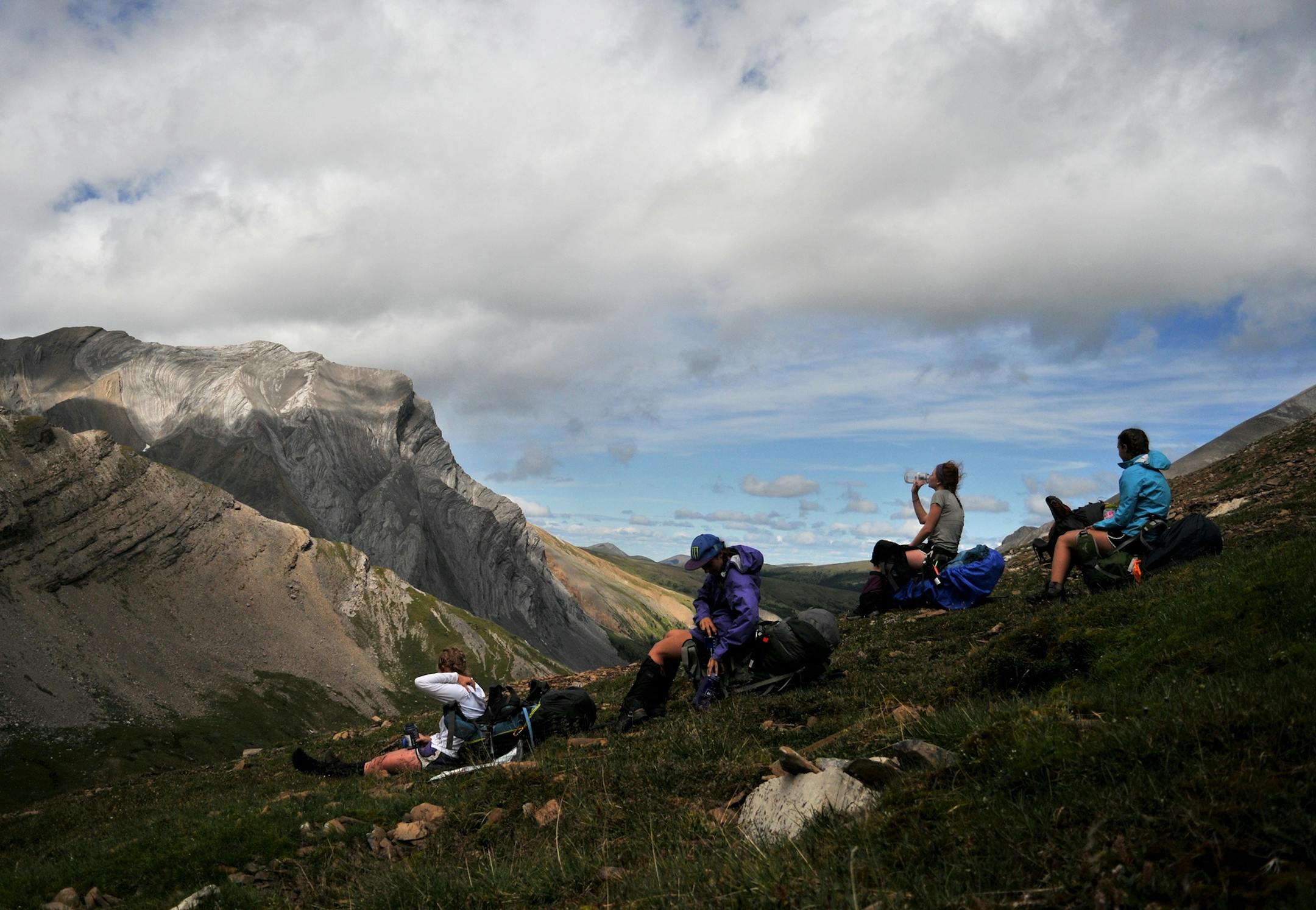 YMCA's Camp Menogyn not only leads teens on wilderness trips into the Boundary Waters. Guides also train campers for backpacking, paddling and climbing adventures around the world. Here a group of Menogyn campers rests on a mountainside in Alaska during a guided backpacking trip.