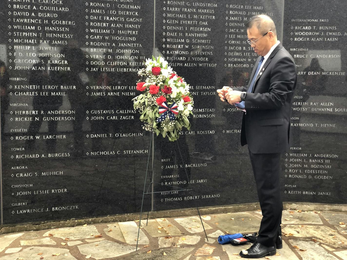 Chihn Pham lies a wreath in front of the Northland Vietnam Veterans Memorial. Pham and members of his family were rescued by the USS Duluth in 1975 during the Vietnam War.