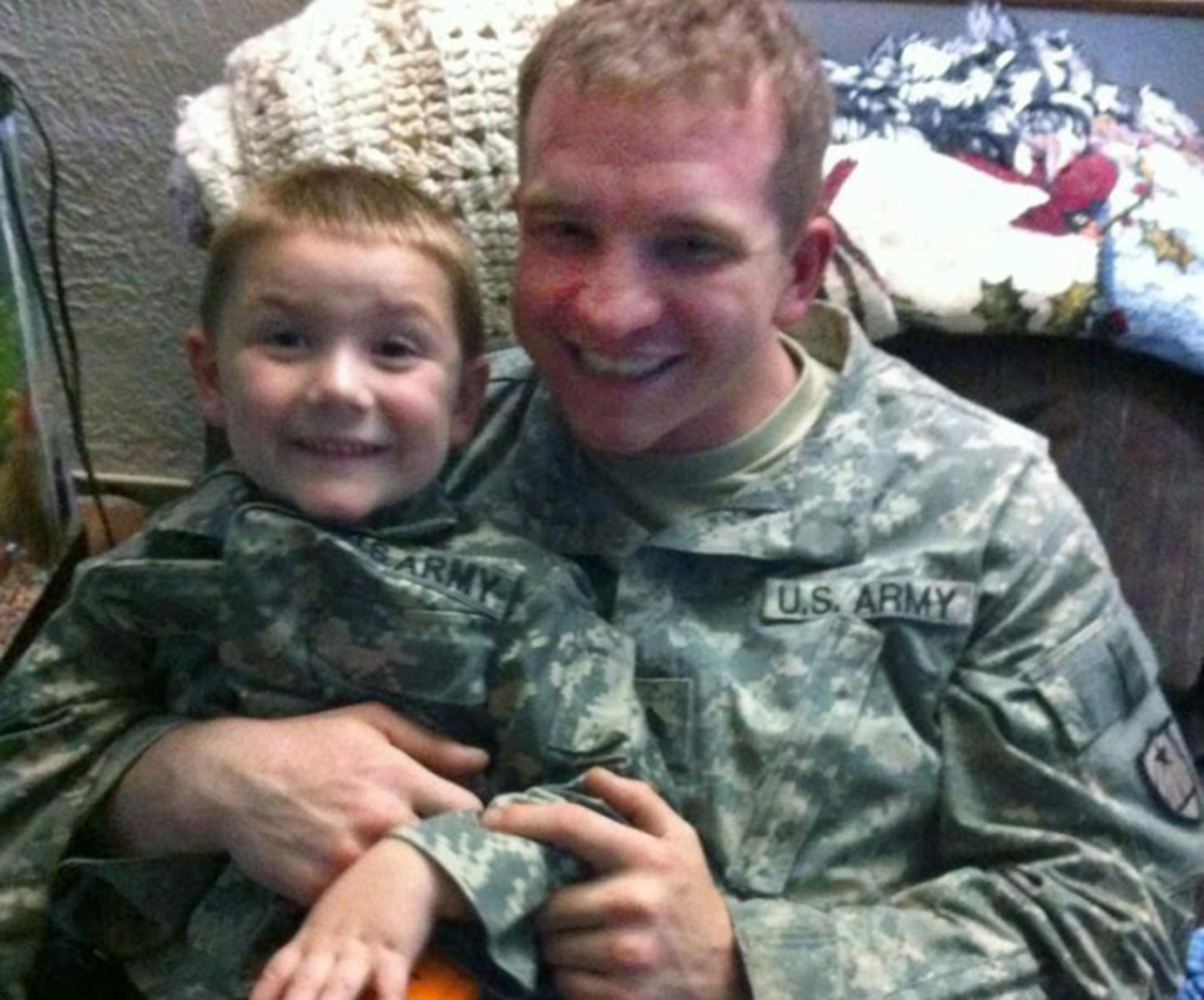 Robbie Sheets (pictured with a young nephew) was among the five Minnesotans injured in Afghanistan.