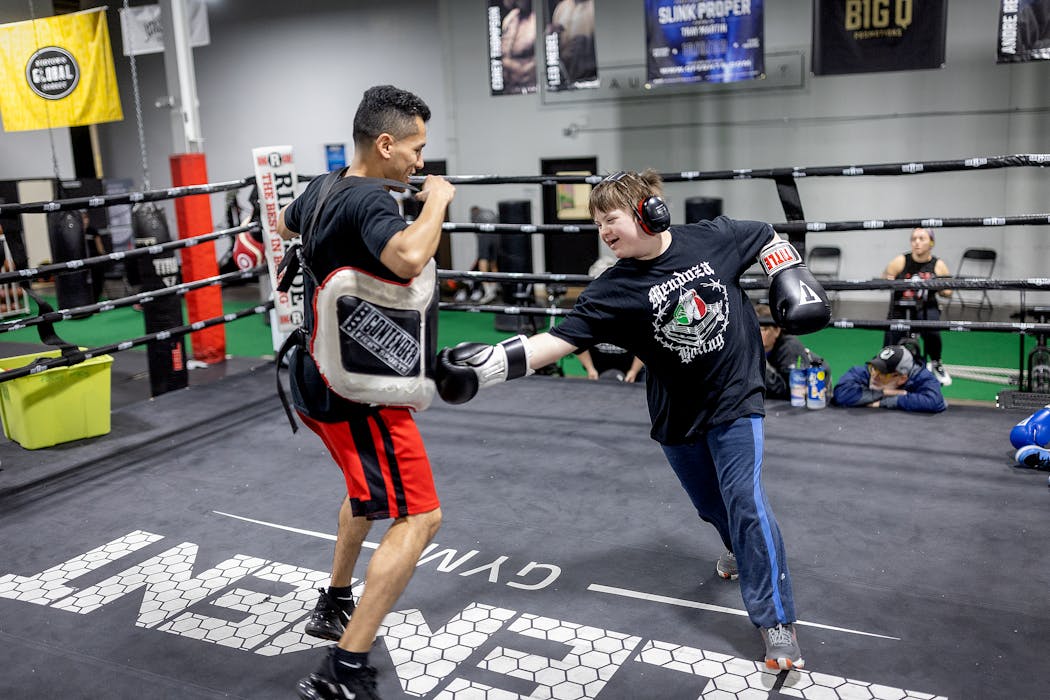 Boxing coach Jorge Mendoza went into the ring with Harmon Fisher, 13, at Element Gym in St. Paul.