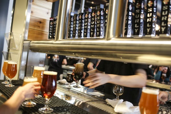Beers being poured at the Surly brew-pub tap room public grand opening in Minneapolis, Minn. on Friday, December 19, 2014.
