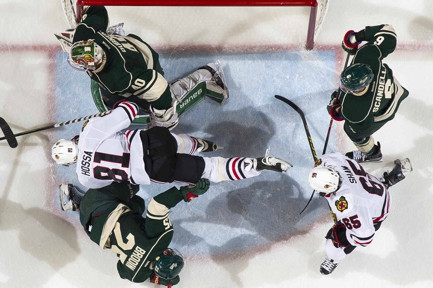 Blackhawks right wing Marian Hossa (81) was knocked into the air during a collision with Wild defenseman Jonas Brodin (25) in front of Minnesota's goal in the third period.