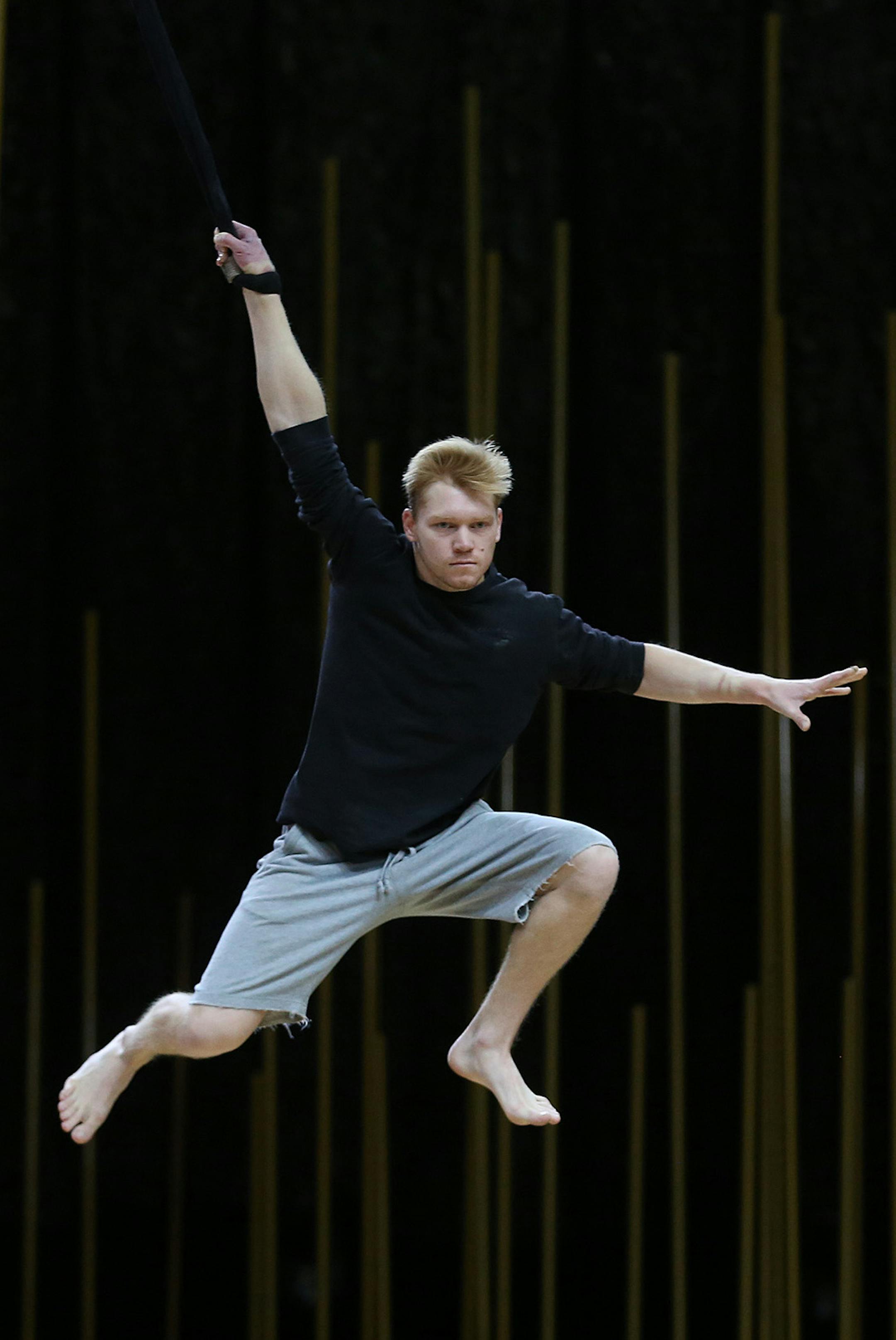 Oleksandr Romashyn, left, and Oleksii Kozakov flew through the air to reach each other during rehearsal. ] (KYNDELL HARKNESS/STAR TRIBUNE) kyndell.harkness@startribune.com Cirque du Soleil Varekai open practice at the Target Center in Minneapolis Min., Wednesday, December 24, 2014. ORG XMIT: MIN1412241227130829