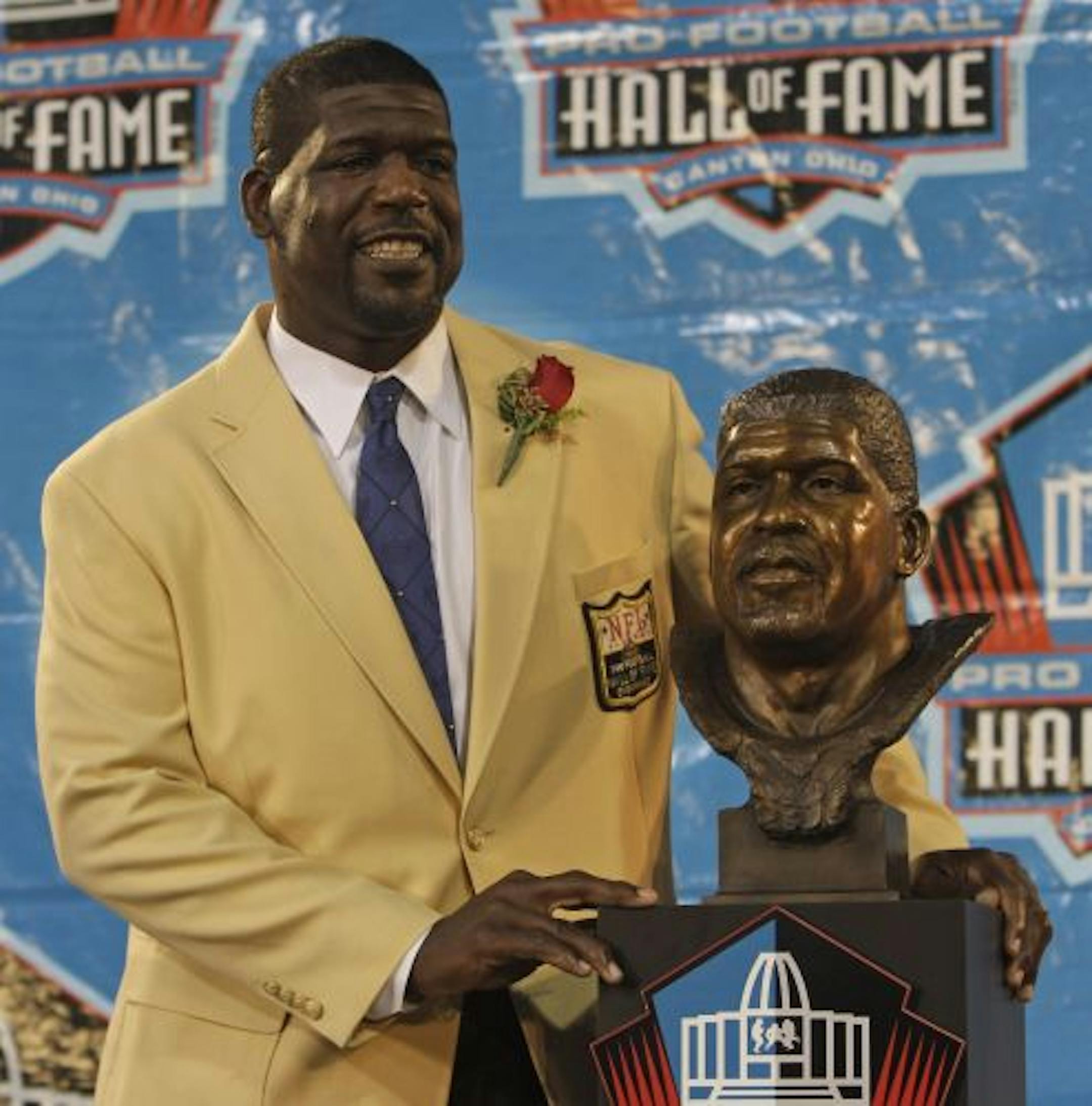 Randall McDaniel stands with his bronze bust during the Pro Football Hall of Fame induction ceremony at the Pro Football Hall of Fame, Saturday, Aug. 8, 2009, in Canton, Ohio.