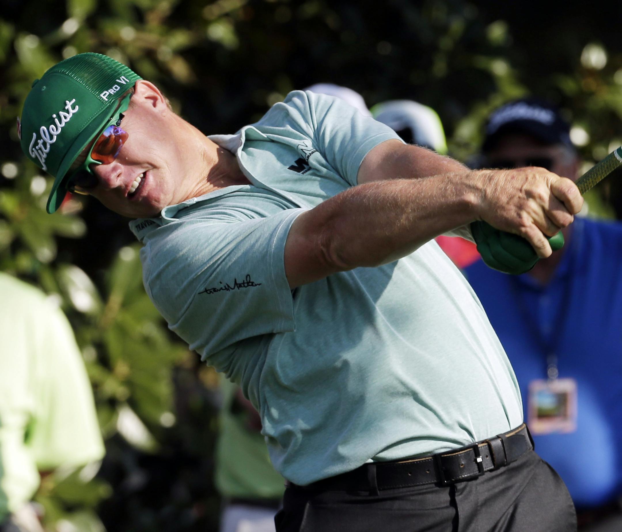Charley Hoffman tees off on the ninth hole during the first round of the Masters golf tournament Thursday, April 9, 2015, in Augusta, Ga. (AP Photo/Charlie Riedel)