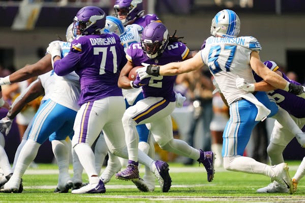 Minnesota Vikings running back Alexander Mattison (2) rushes the ball past Detroit Lions defensive end Aidan Hutchinson (97) in the second quarter of 
