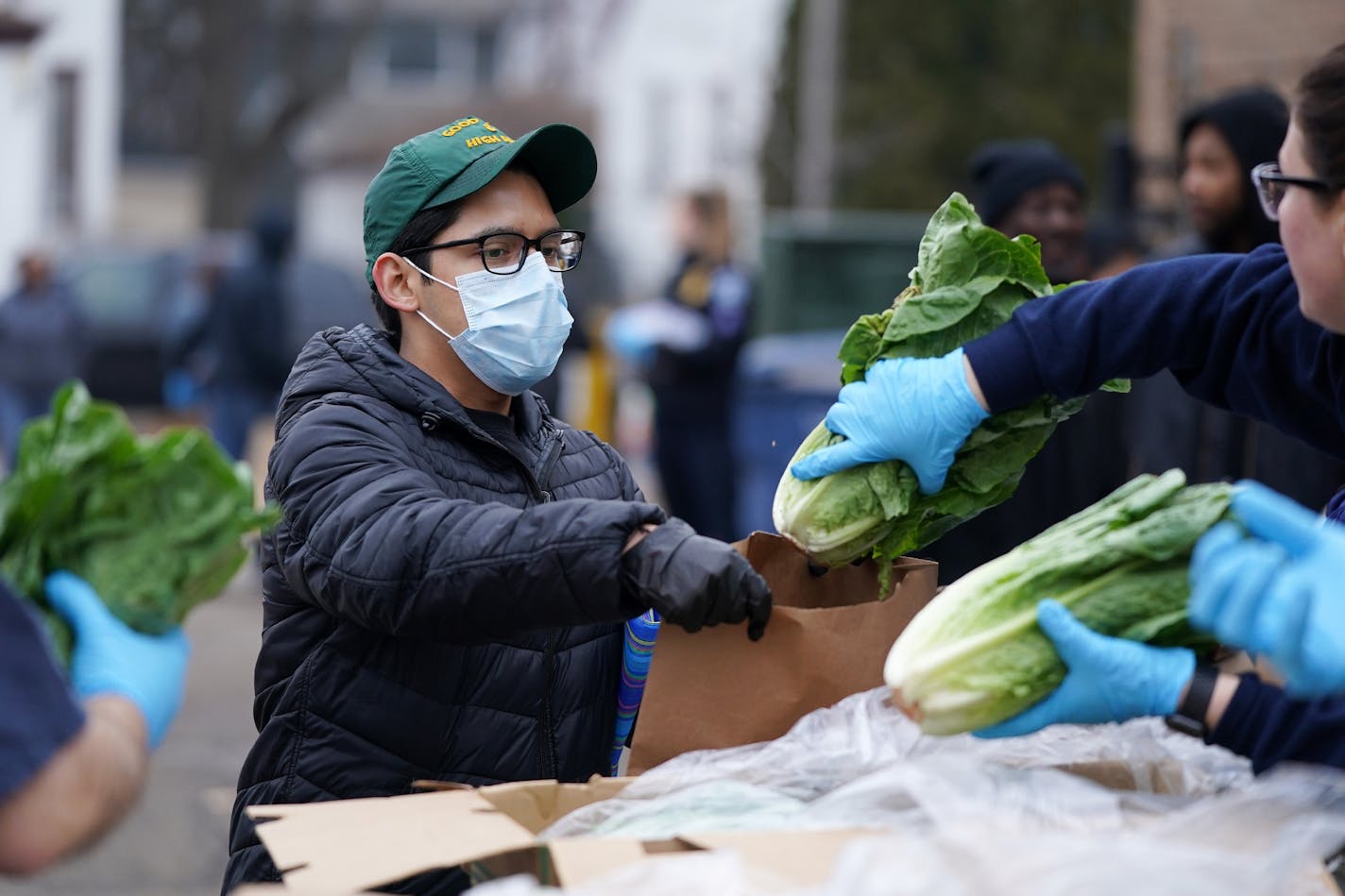 A man wore a mask as he was given a head of lettuce during the free grocery giveaway event Wednesday at the Minneapolis Police Activities League. ] ANTHONY SOUFFLE &#x2022; anthony.souffle@startribune.com The Minneapolis Police Department, University of Minnesota Extension, Metro Transit Police Department, and Society of St. Vincent De Paul offered a free grocery giveaway event for those impacted by the Coronavirus closures Wednesday, March 18, 2020 at the Minneapolis Police Activities League in