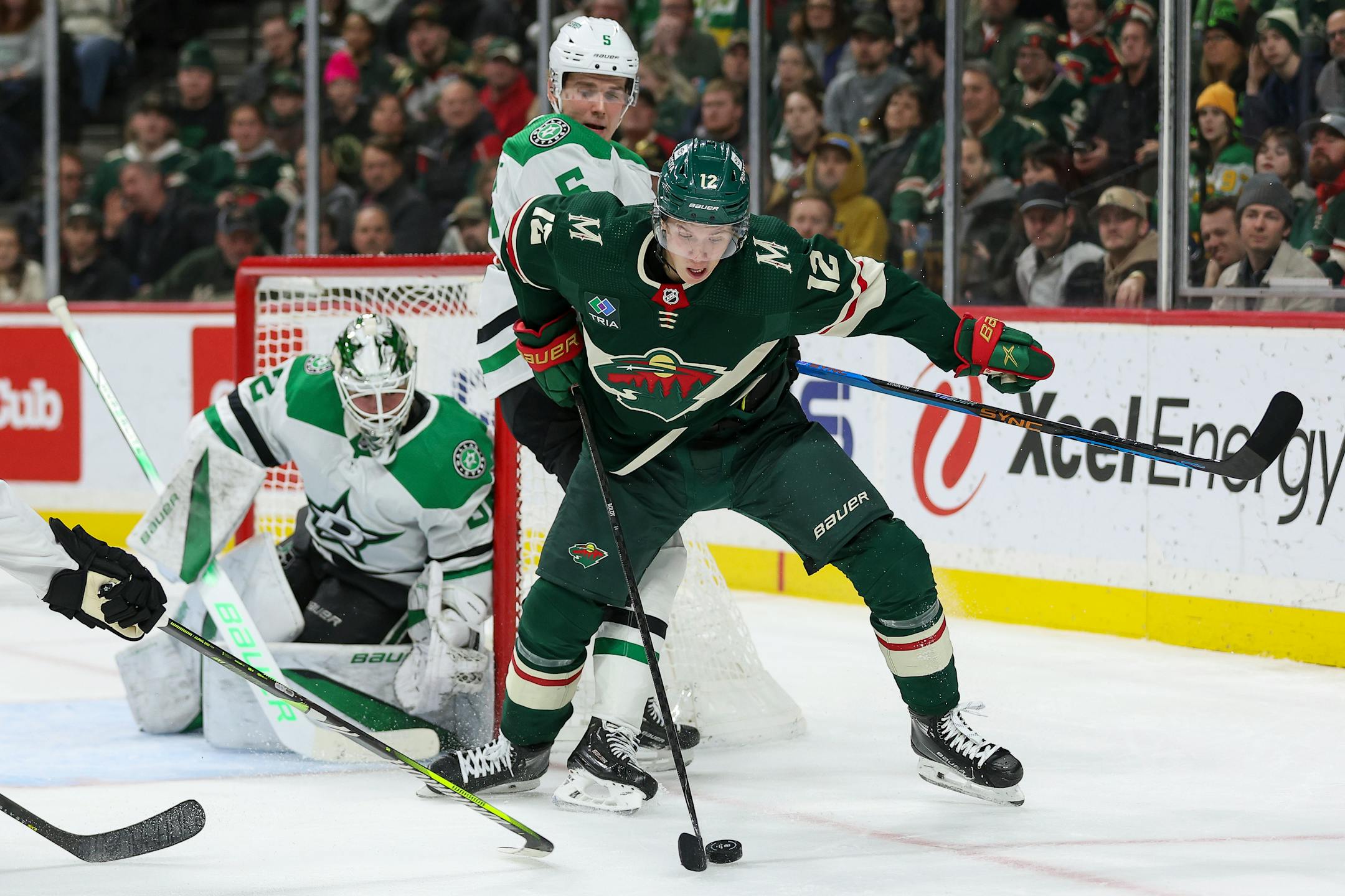 Minnesota Wild left wing Matt Boldy, right, and Dallas Stars defenseman Nils Lundkvist (5) compete for the puck during the second period of an NHL hockey game Monday, Jan. 8, 2024, in St. Paul, Minn. (AP Photo/Matt Krohn)
